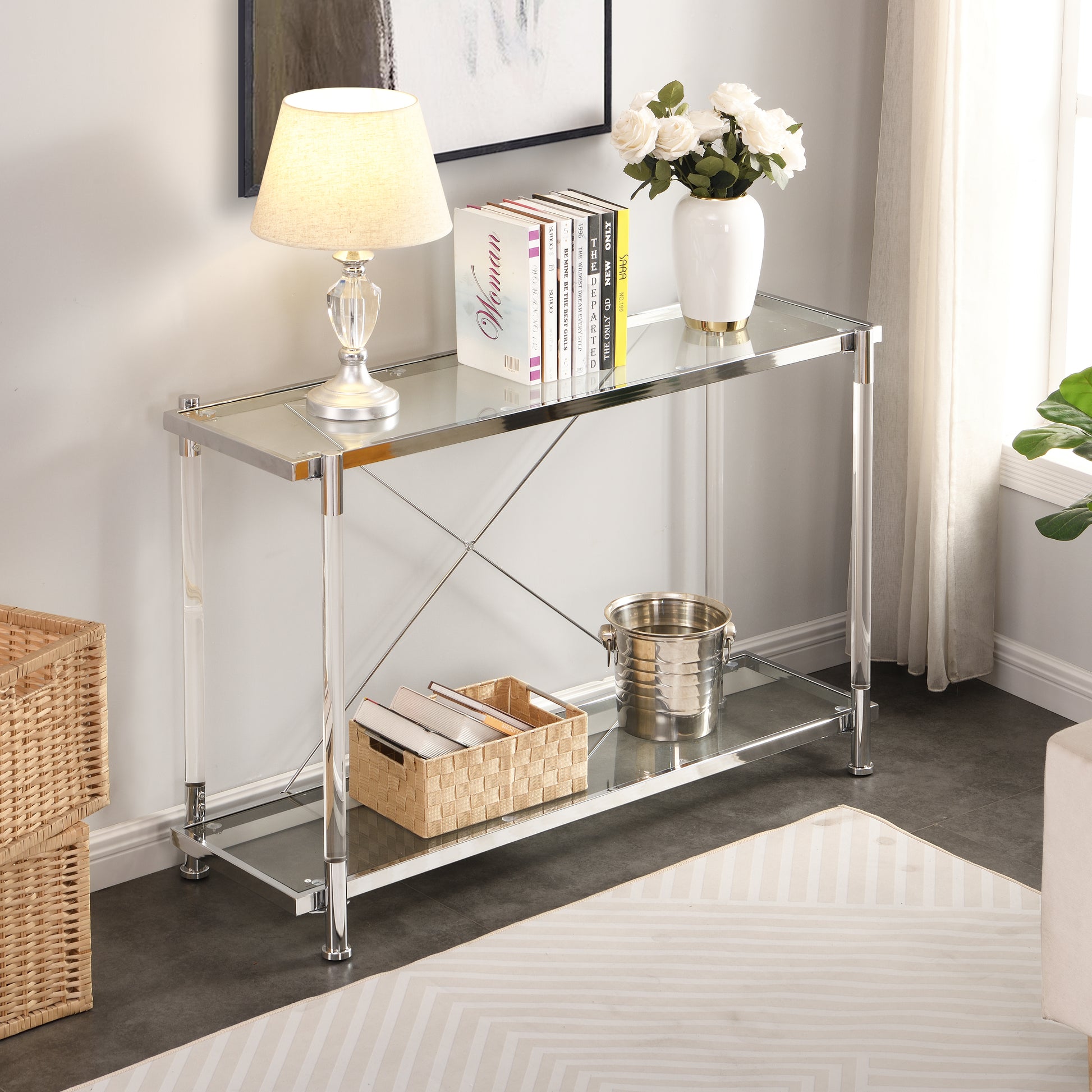 Modern clear acrylic console table with chrome accents and glass shelves