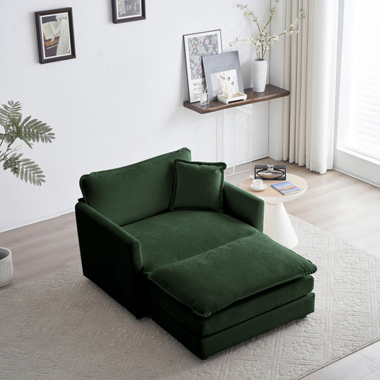 Deep green velvet chaise lounge with attached ottoman and accent pillow