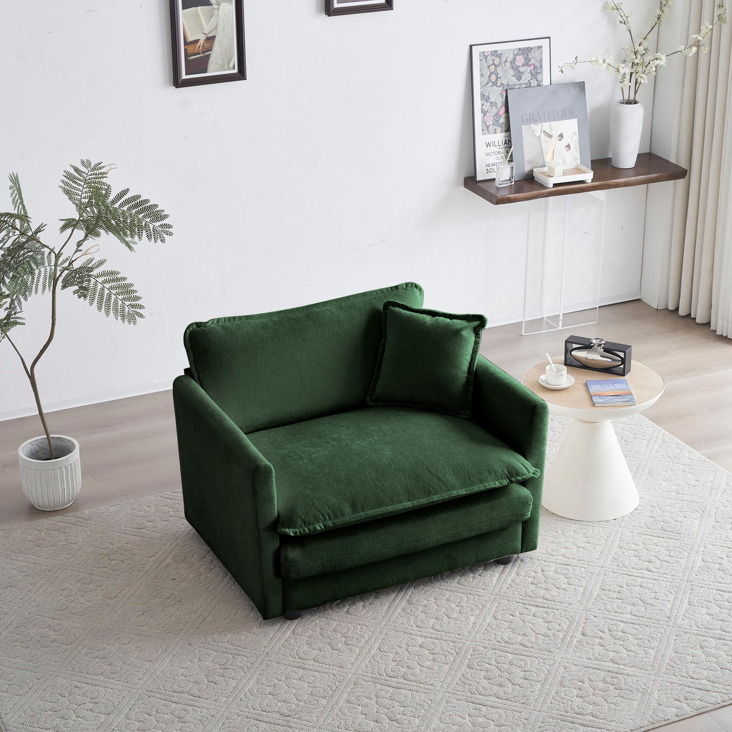 Deep green velvet loveseat with plush cushions and a matching throw pillow