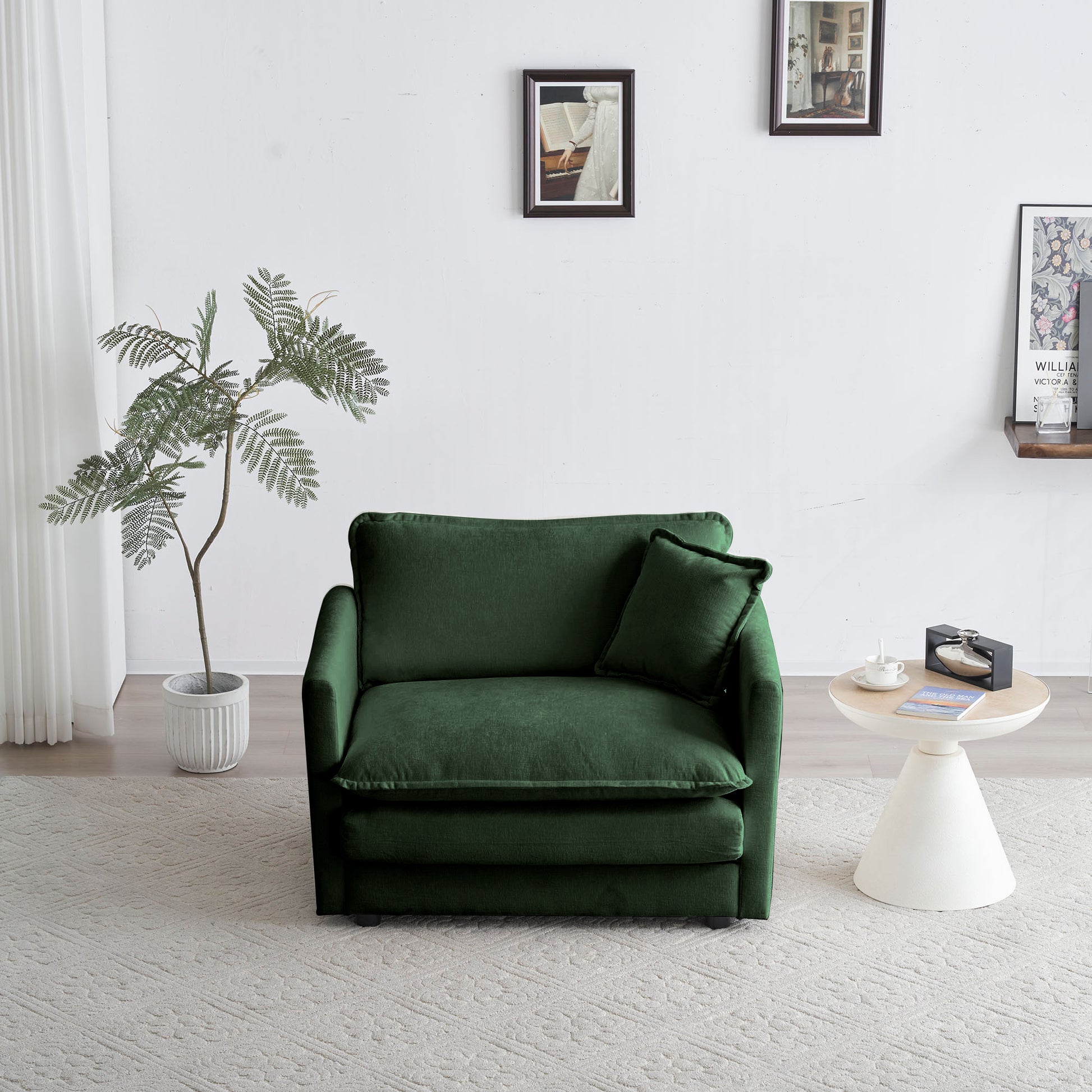 Deep green velvet armchair with plush cushions and a matching throw pillow
