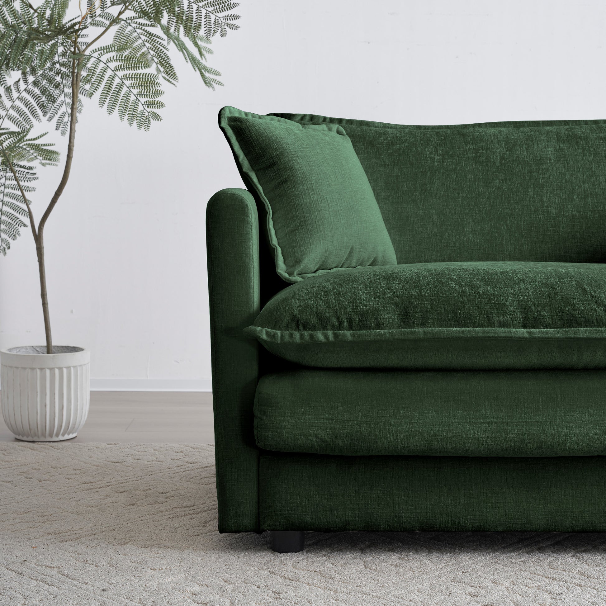 Deep emerald green sectional sofa with plush linenlook fabric and accent pillow