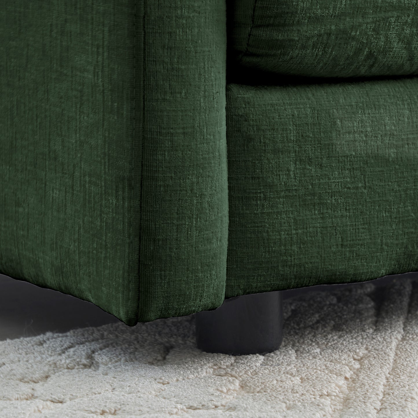 Deep green textured fabric sofa armrest detail modern home decor