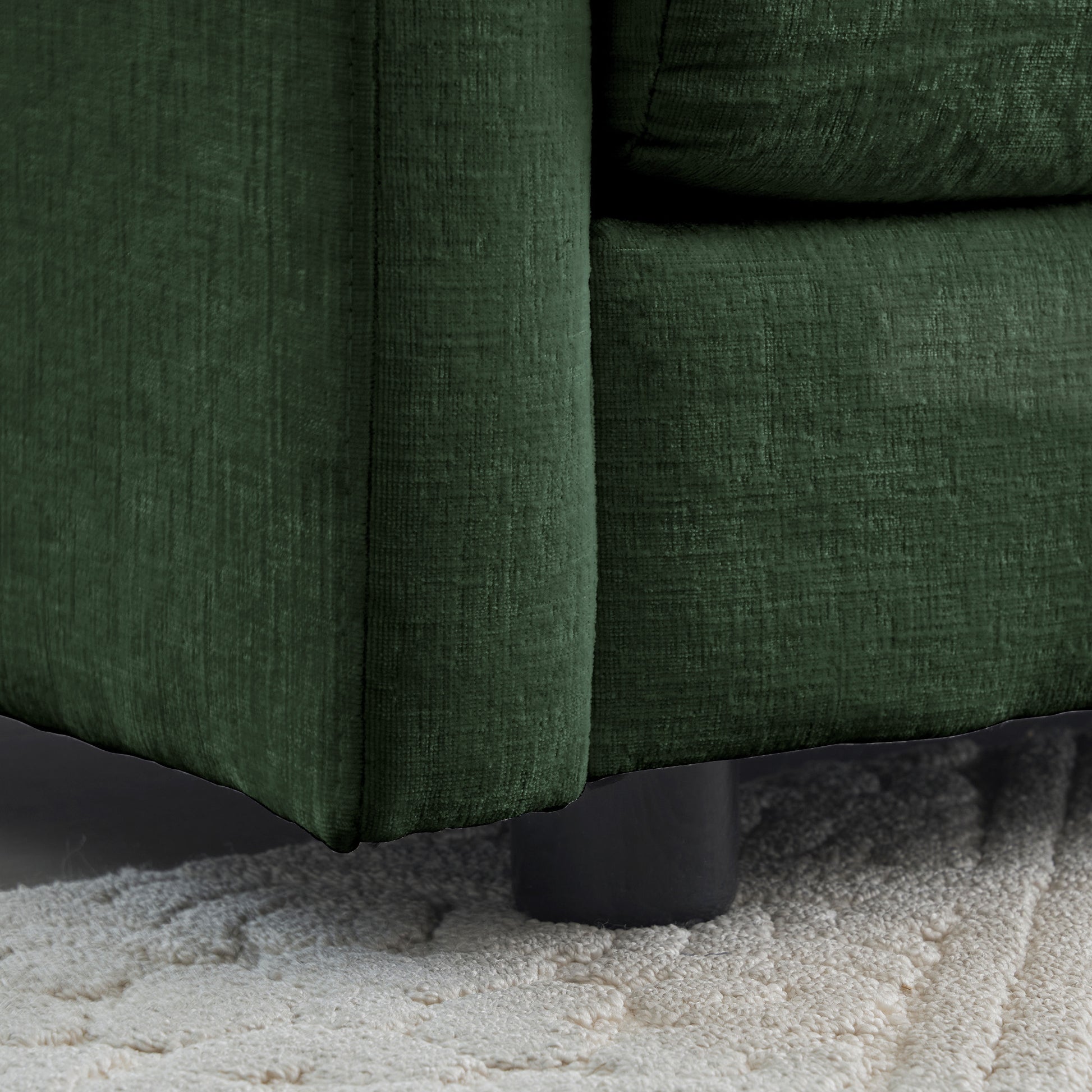 Deep green textured fabric sofa armrest detail modern home decor