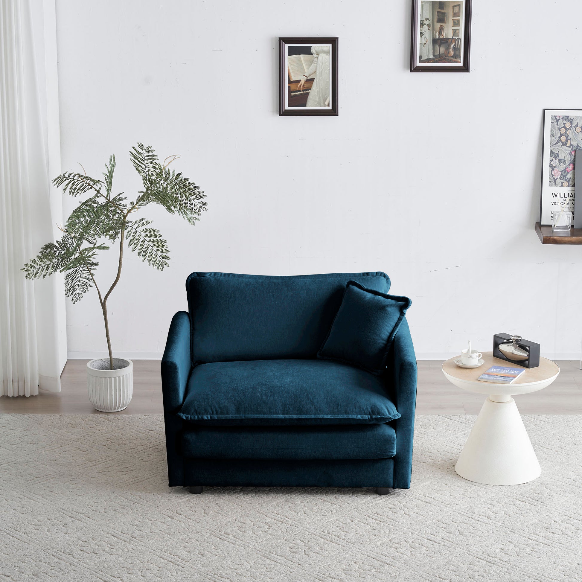 Plush teal velvet accent chair with matching pillow ideal for small spaces