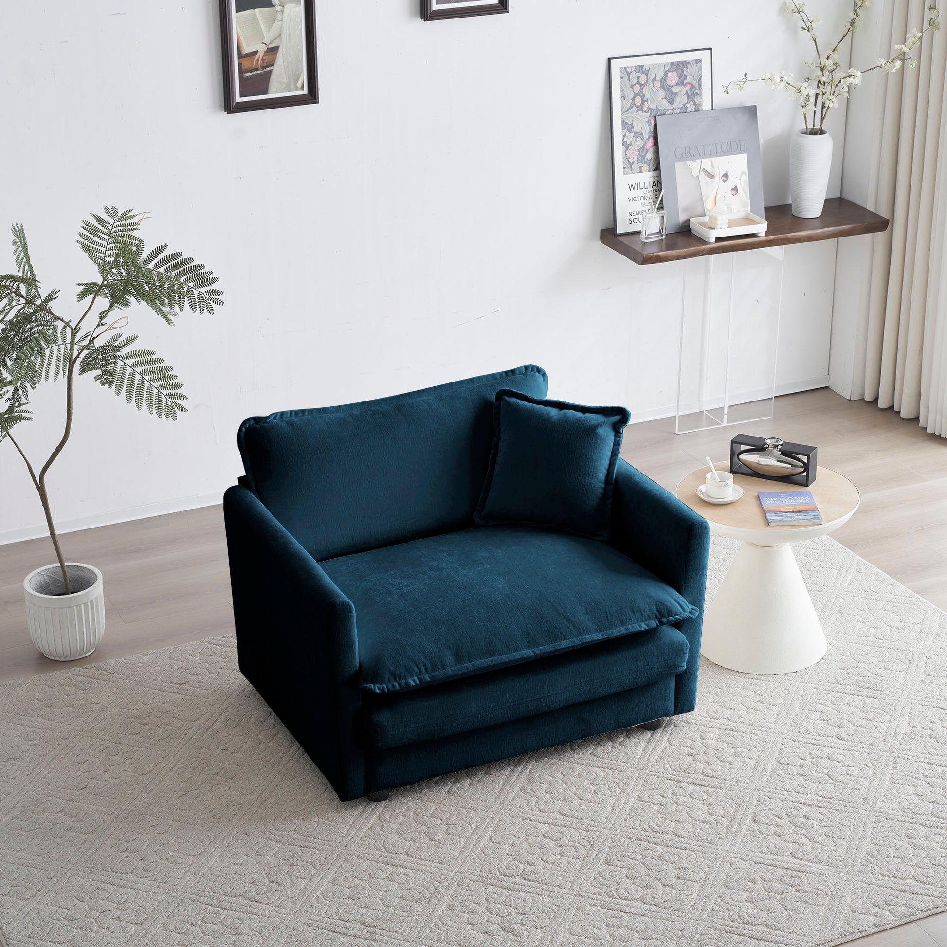 Plush teal velvet armchair with a matching accent pillow perfect for a cozy reading nook
