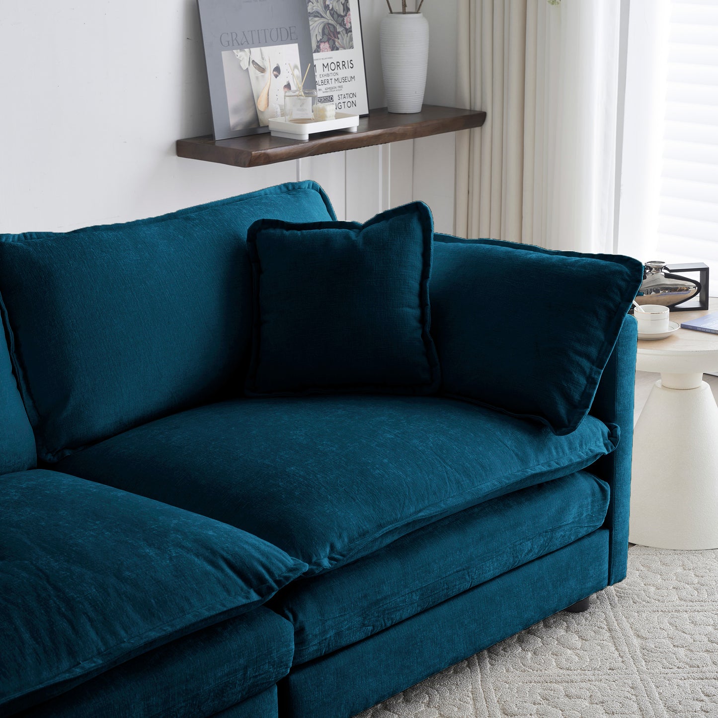Deep teal velvet sectional sofa with plush throw pillows perfect for a modern living room