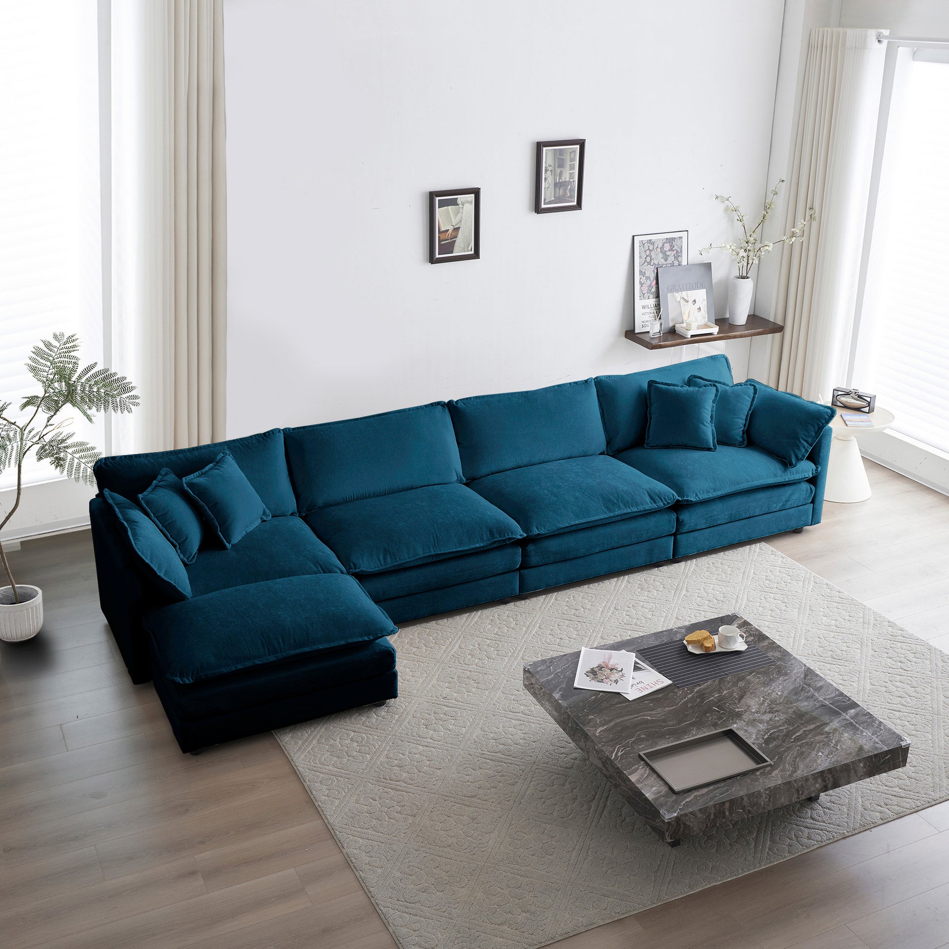 Deep teal velvet sectional sofa with plush cushions and modular design