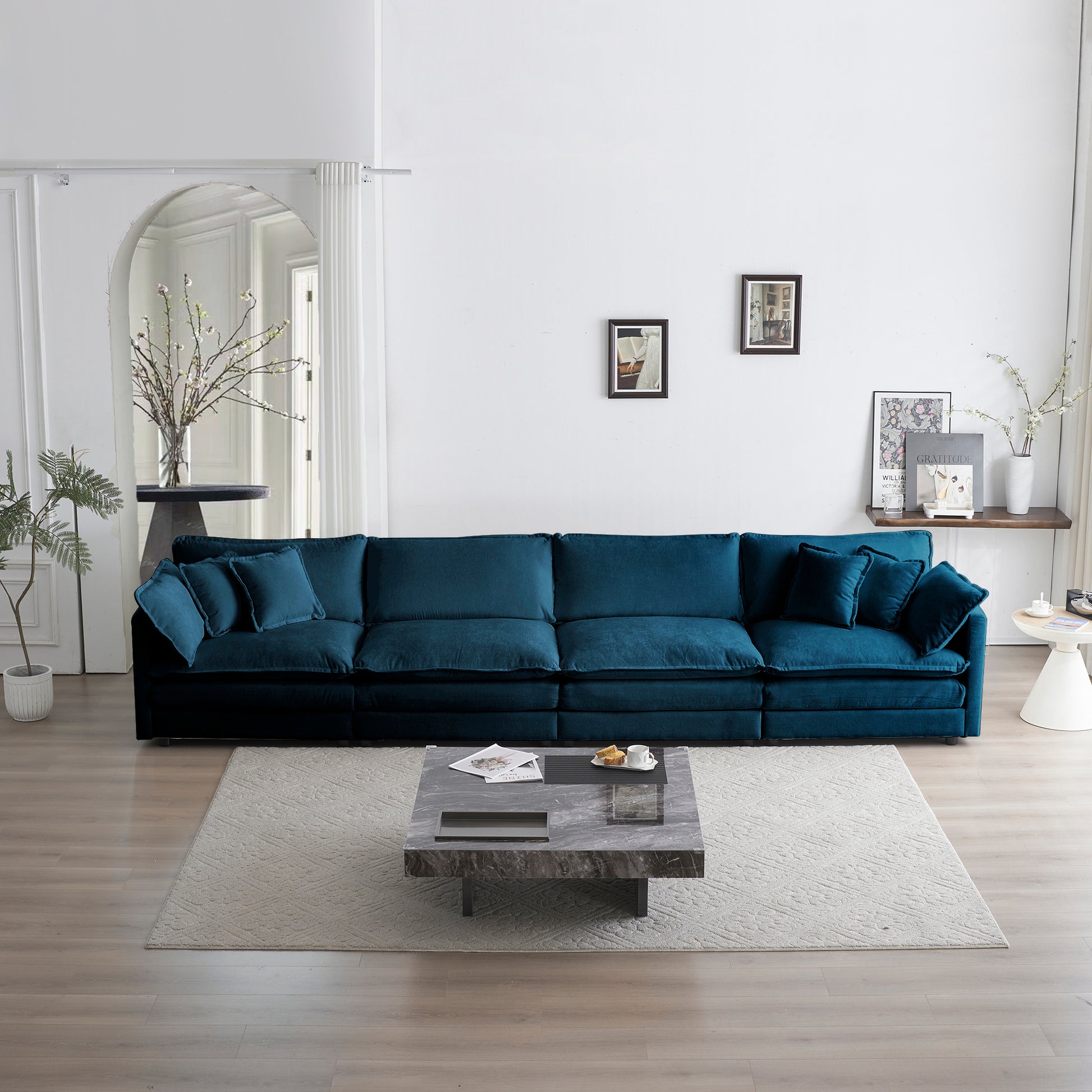 Plush teal velvet sectional sofa with deep seating and matching accent pillows for a modern living room