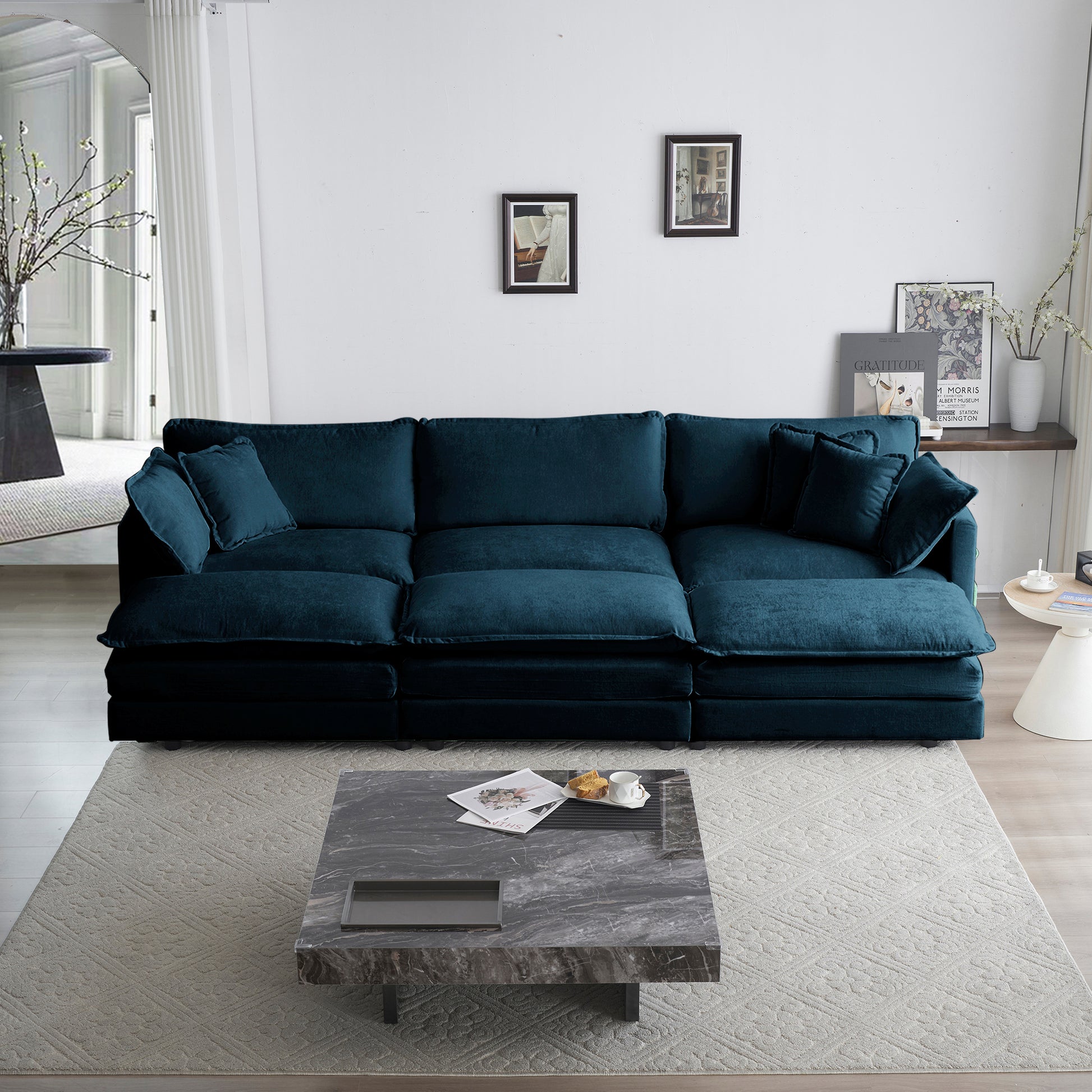 Deep teal velvet sectional sofa with plush cushions and throw pillows for a modern living room