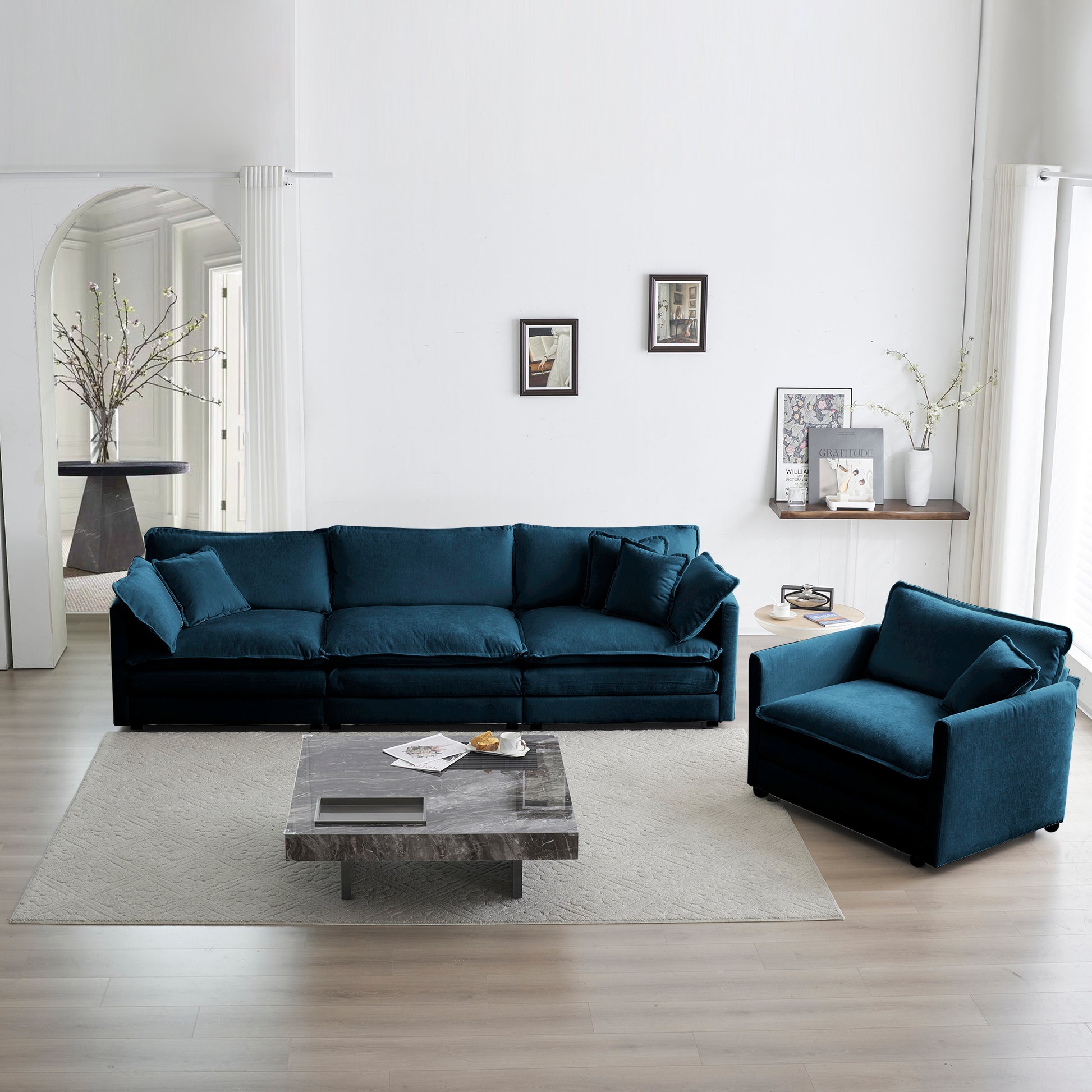 Deep teal velvet sectional sofa with plush cushions and matching accent chair