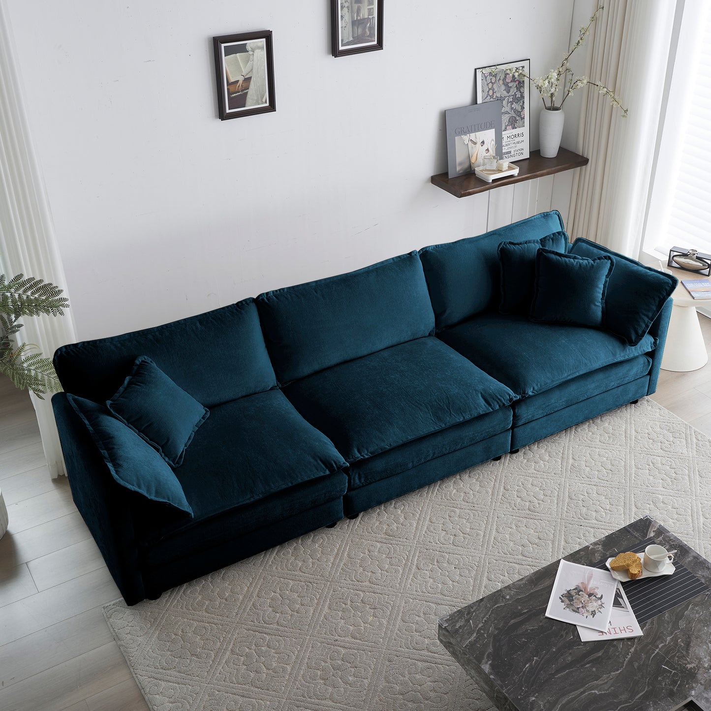 Deep teal velvet sectional sofa with plush cushions for a cozy living room