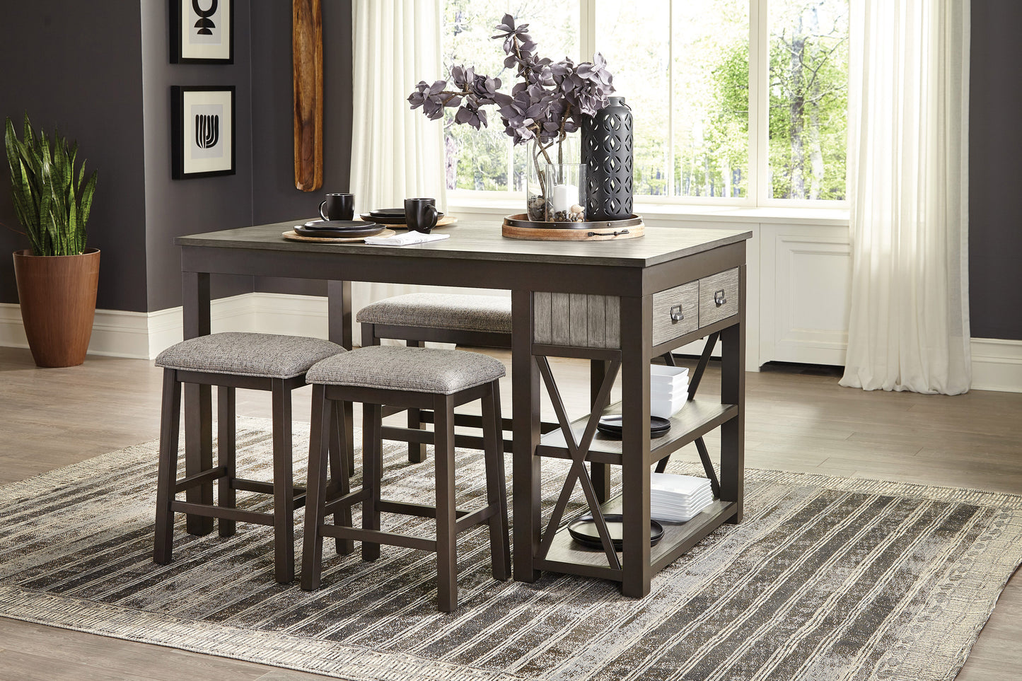 Gray upholstered counter stools at a dark wood dining table with two drawers