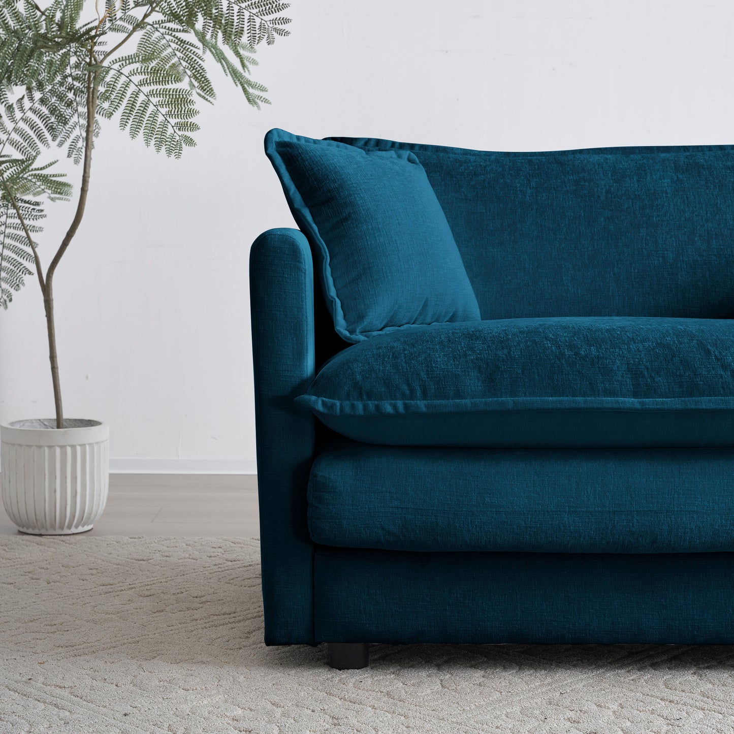 Teal textured fabric sofa with plush cushions and accent pillow