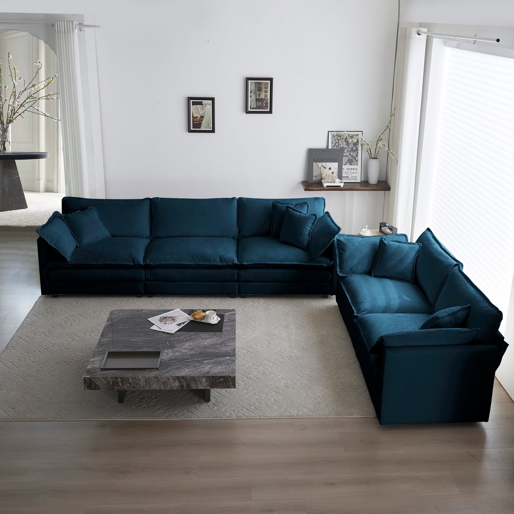 Deep teal modular sectional sofa with plush cushions on a textured rug