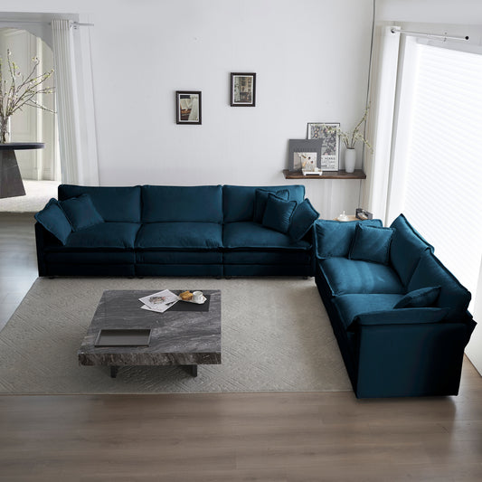 Deep teal modular sectional sofa with plush cushions on a textured rug