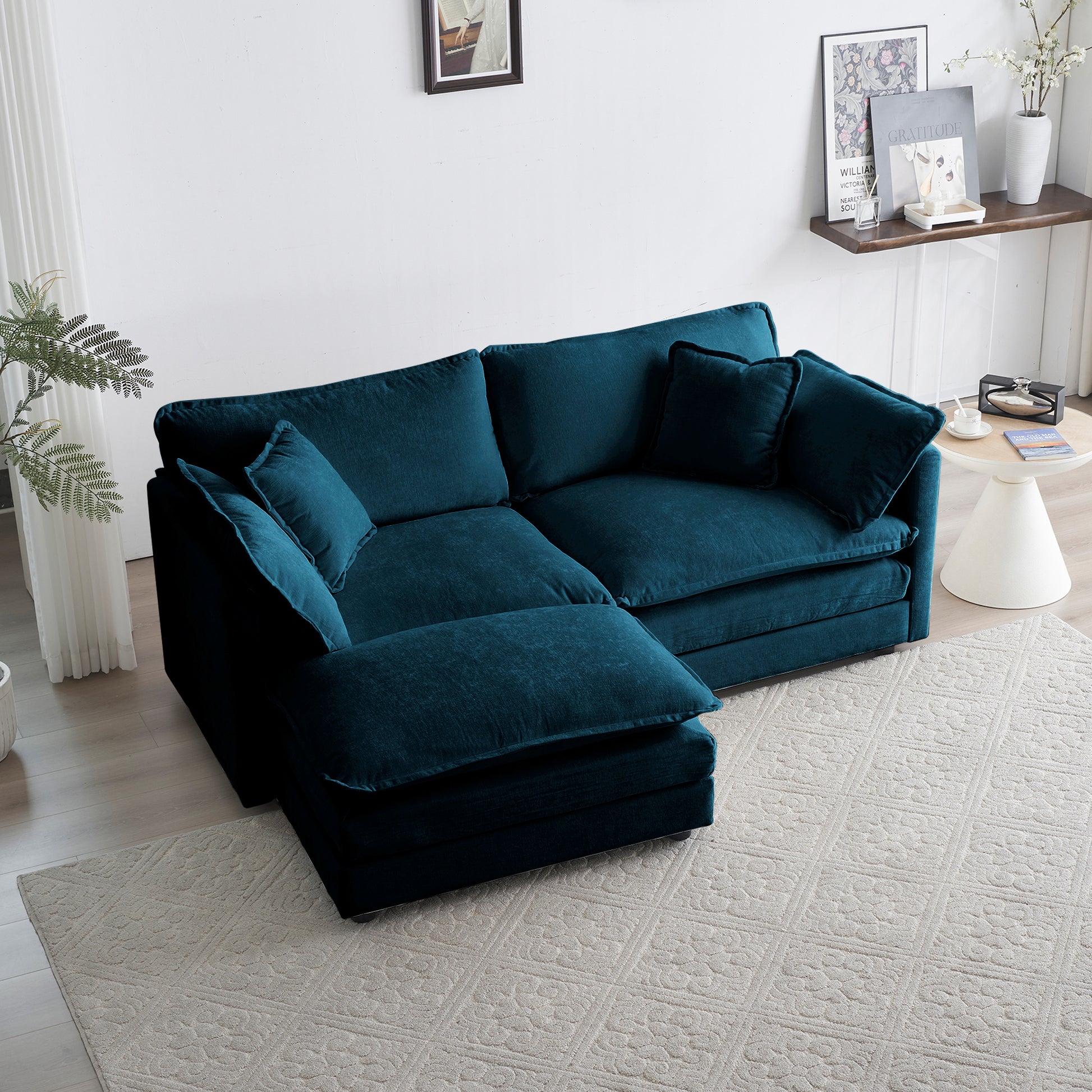 Deep teal velvet sectional sofa with plush cushions offering a luxurious seating experience