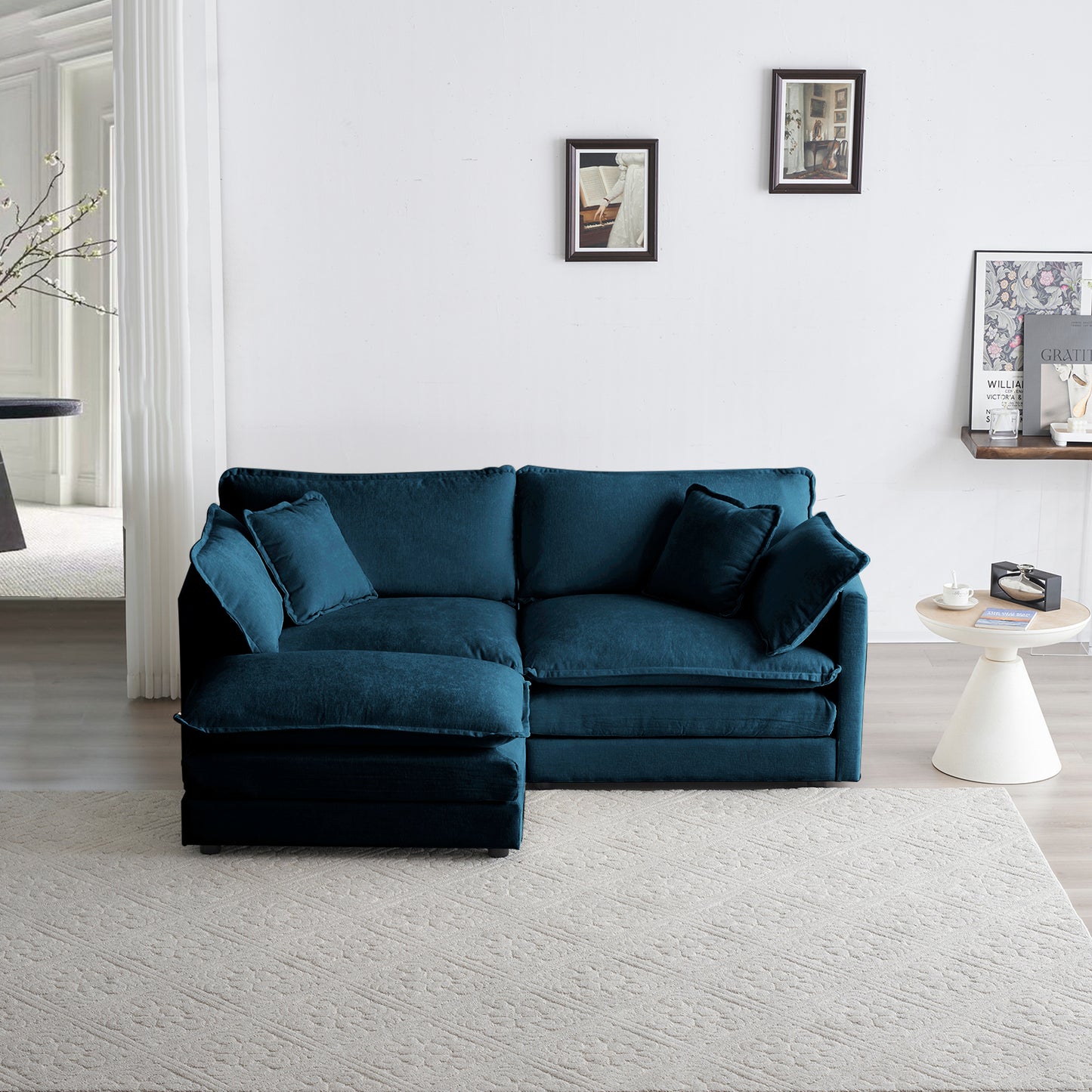Teal sectional sofa with plush cushions on a beige patterned rug