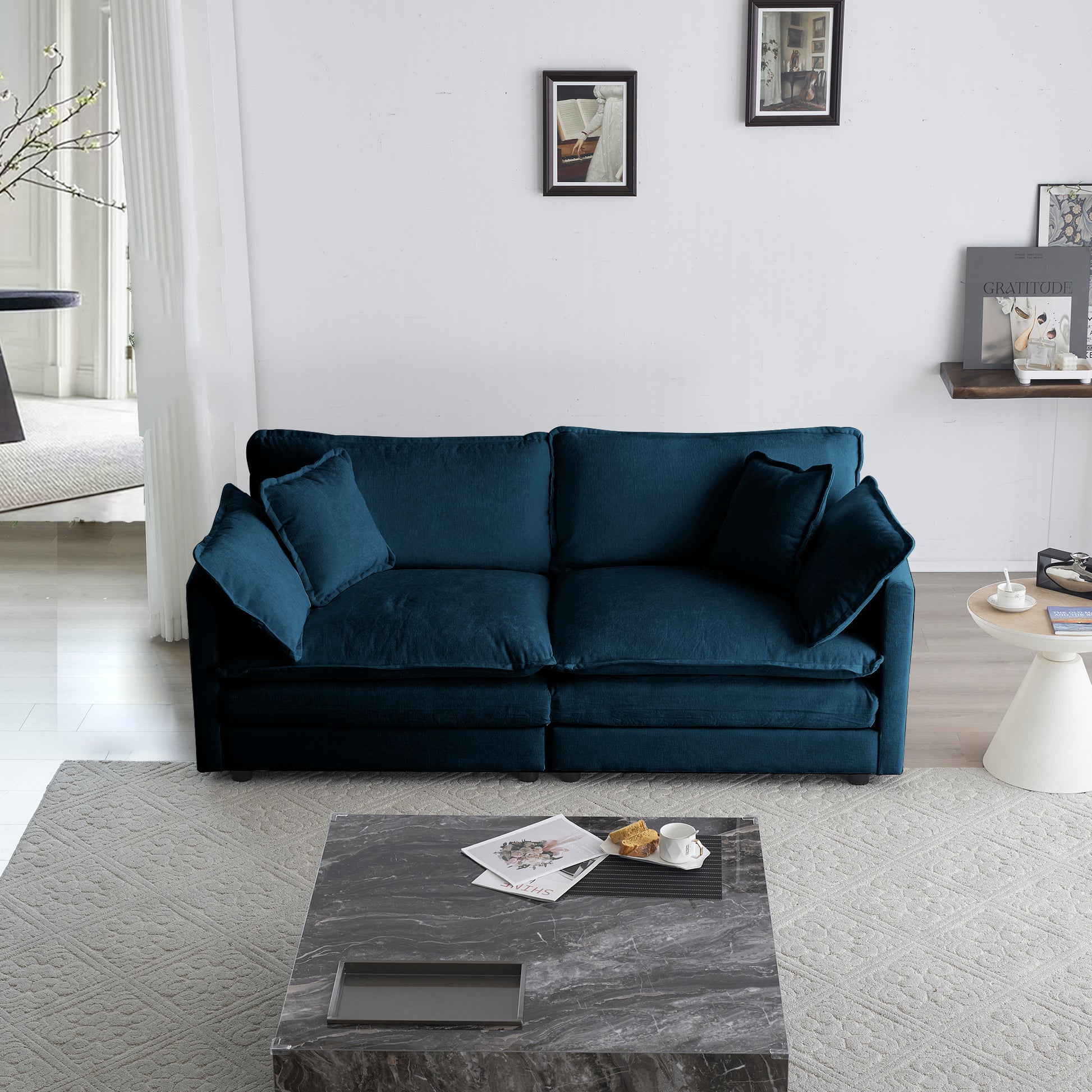 Deep teal velvet sofa with plush cushions and modern design