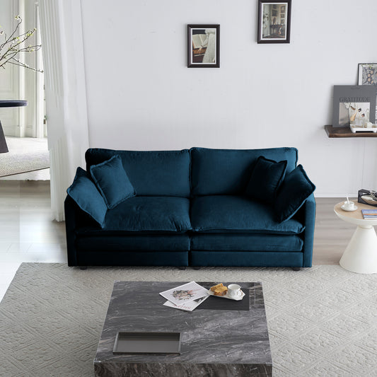 Deep teal velvet sofa with plush cushions and modern design