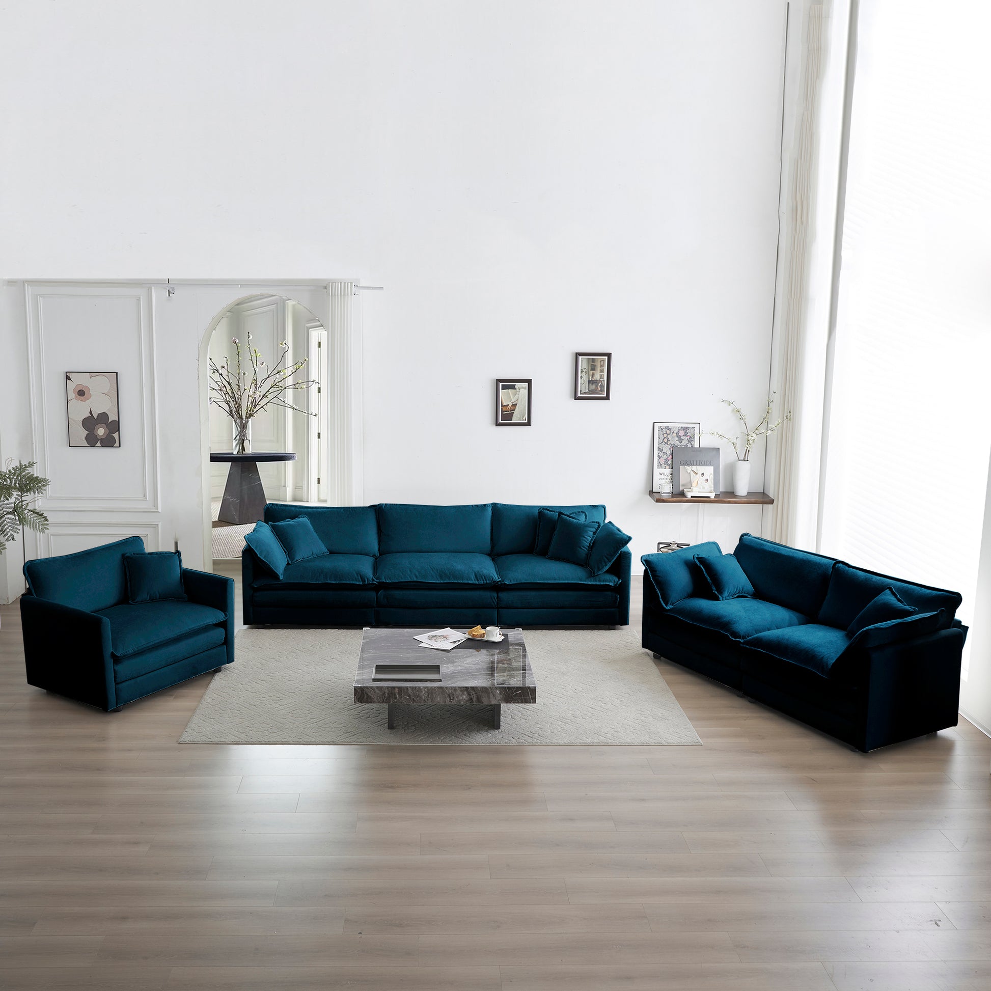 Plush teal velvet sectional sofa with matching armchair and throw pillows for modern living room