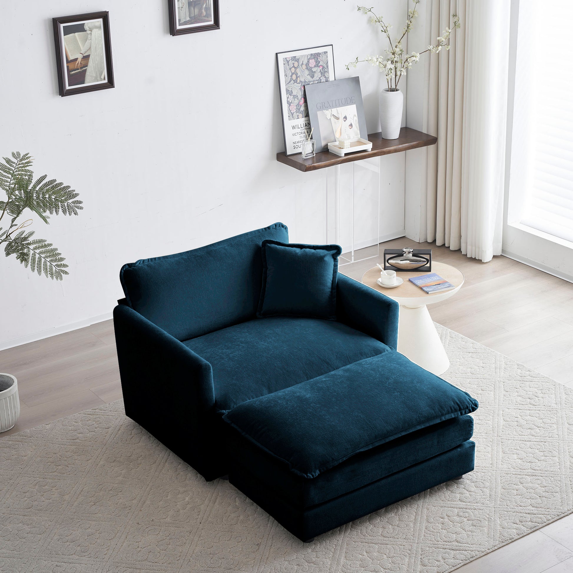 Plush teal velvet chaise lounge with a matching ottoman perfect for modern living rooms