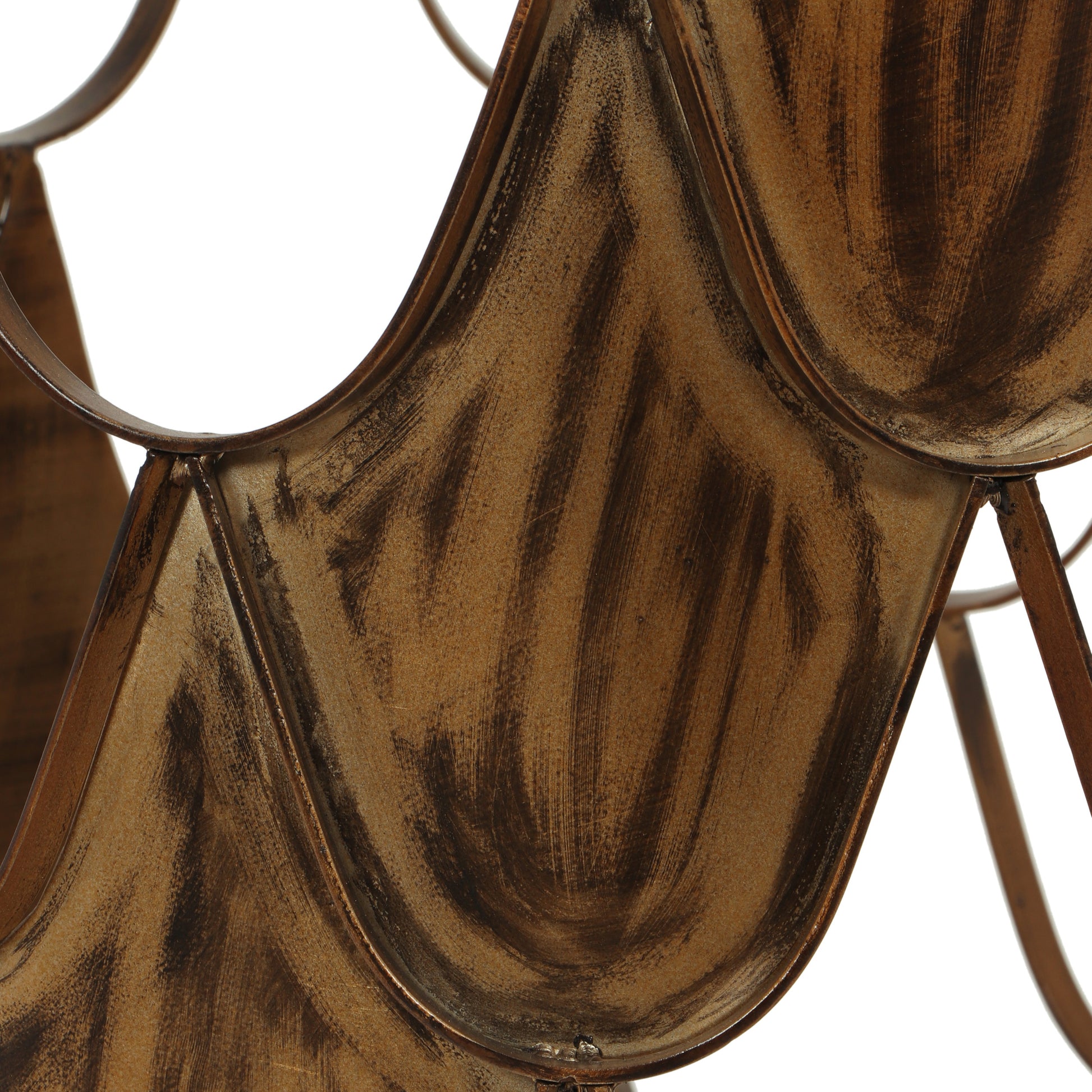 Closeup of a distressed bronze wine rack showing textured metalwork and curved design