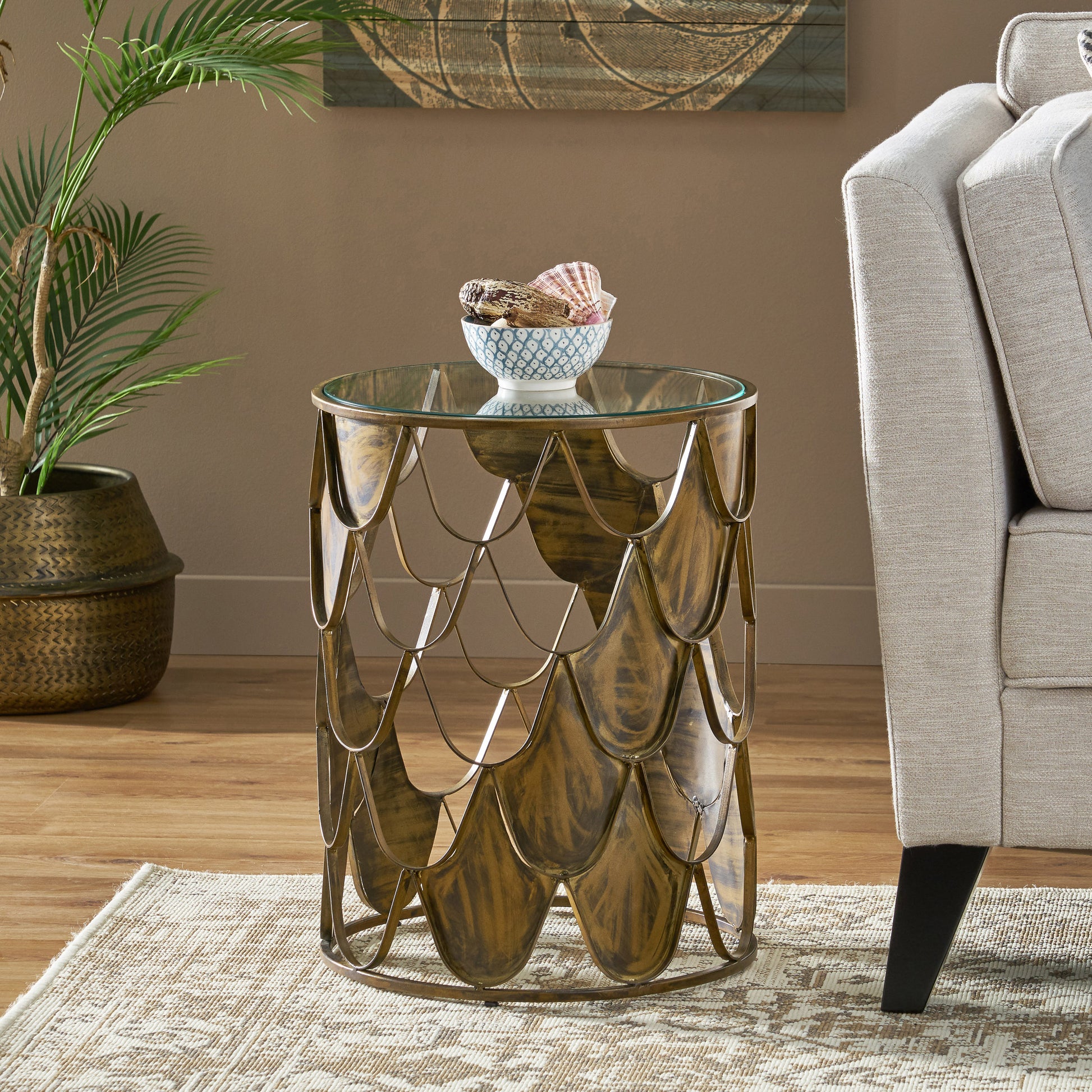 Round glass top side table with ornate gold metal base perfect for living rooms