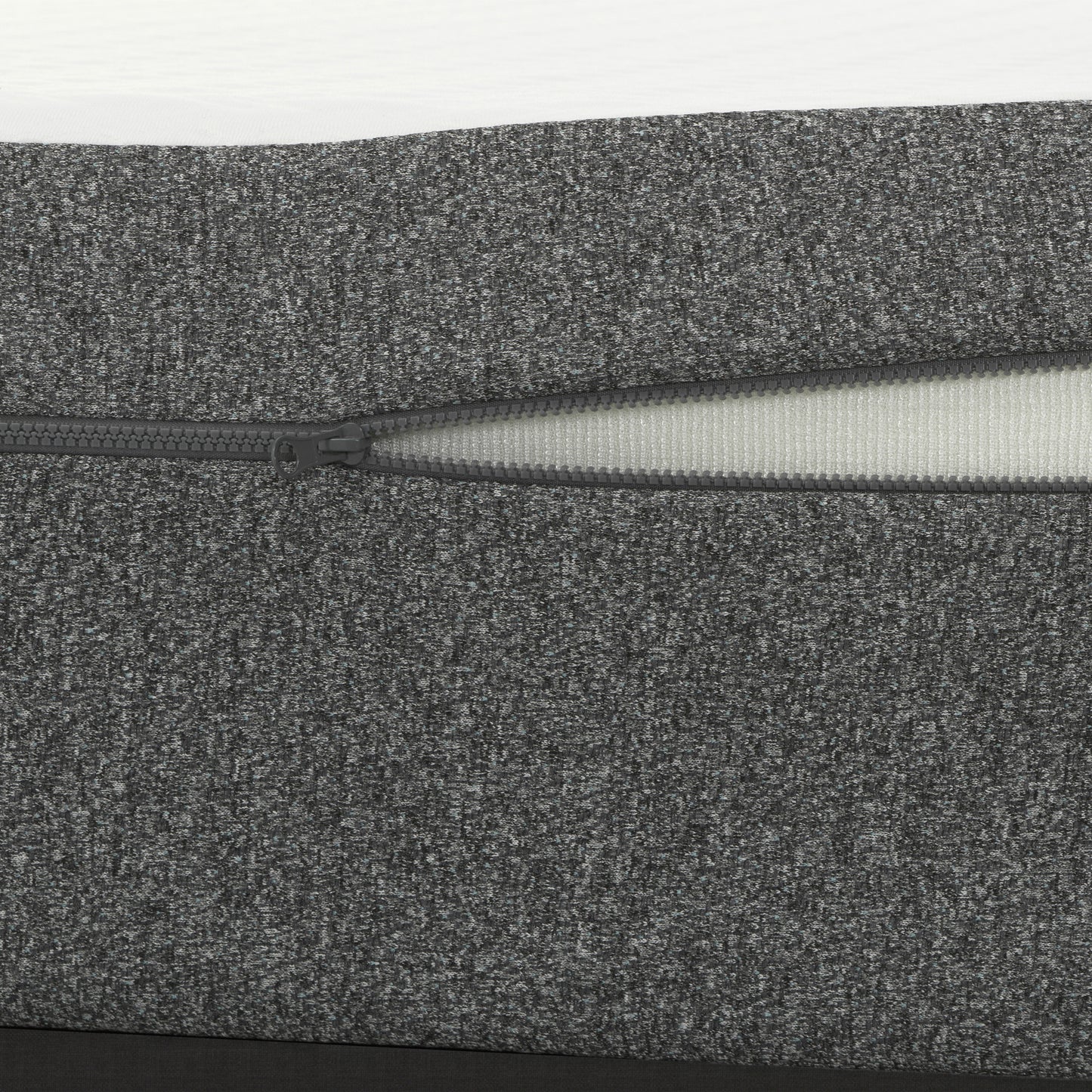 Closeup of charcoal grey textured fabric cover with a visible zipper ideal for furniture