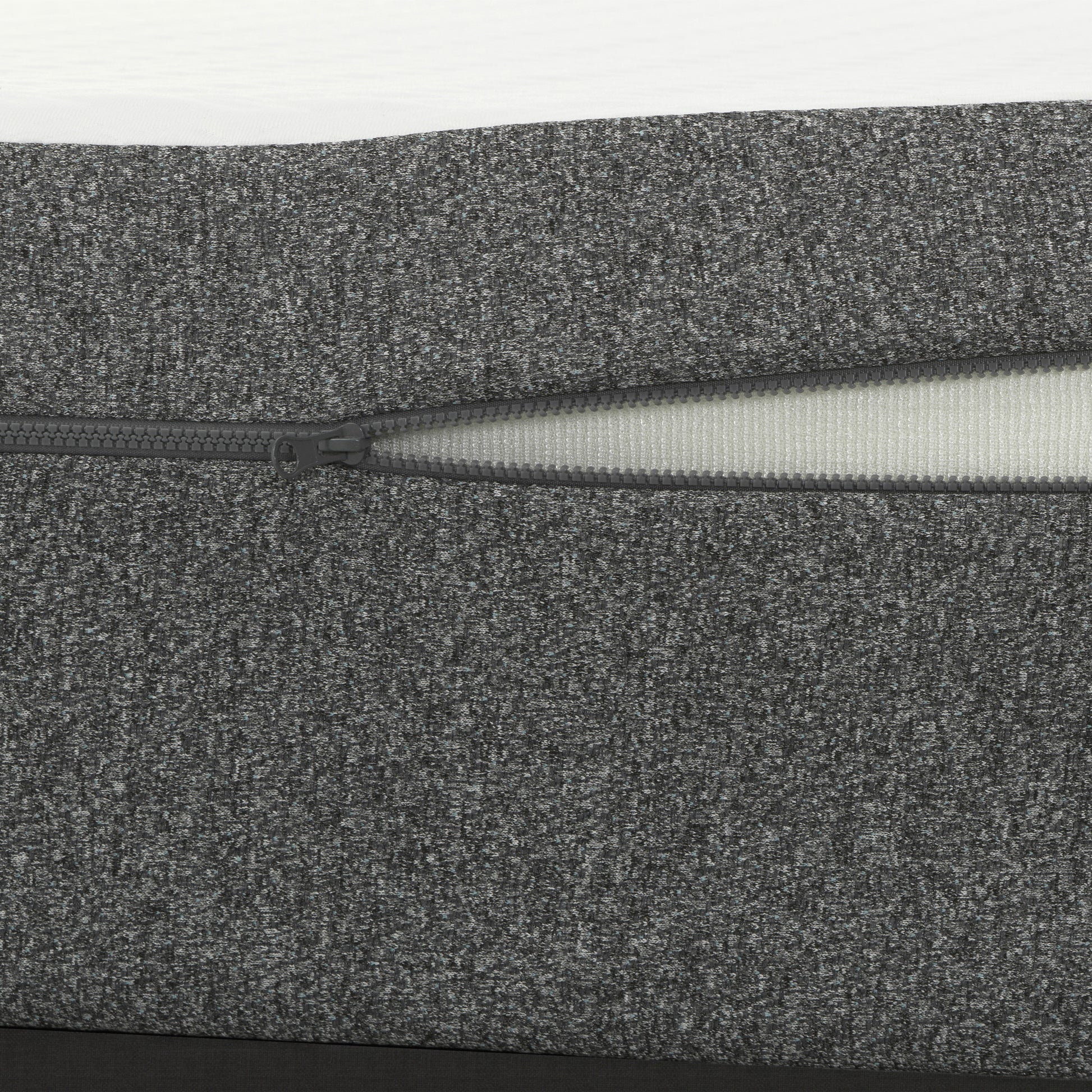 Closeup of charcoal grey textured fabric cover with a visible zipper ideal for furniture