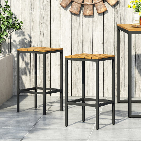Two wooden slatted seat bar stools with black metal frames on an outdoor patio