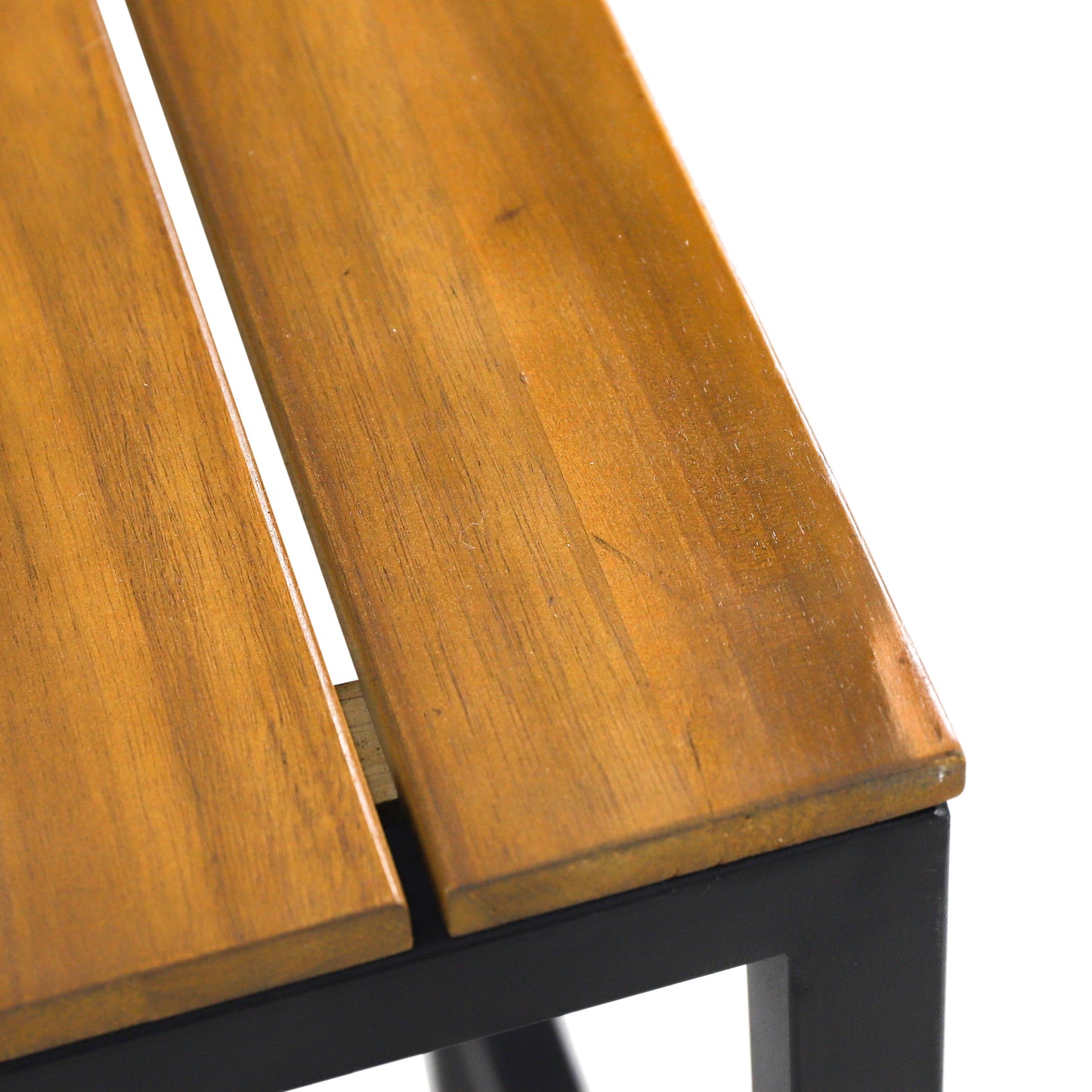 Closeup of a modern wooden slatted outdoor bench with a black metal frame