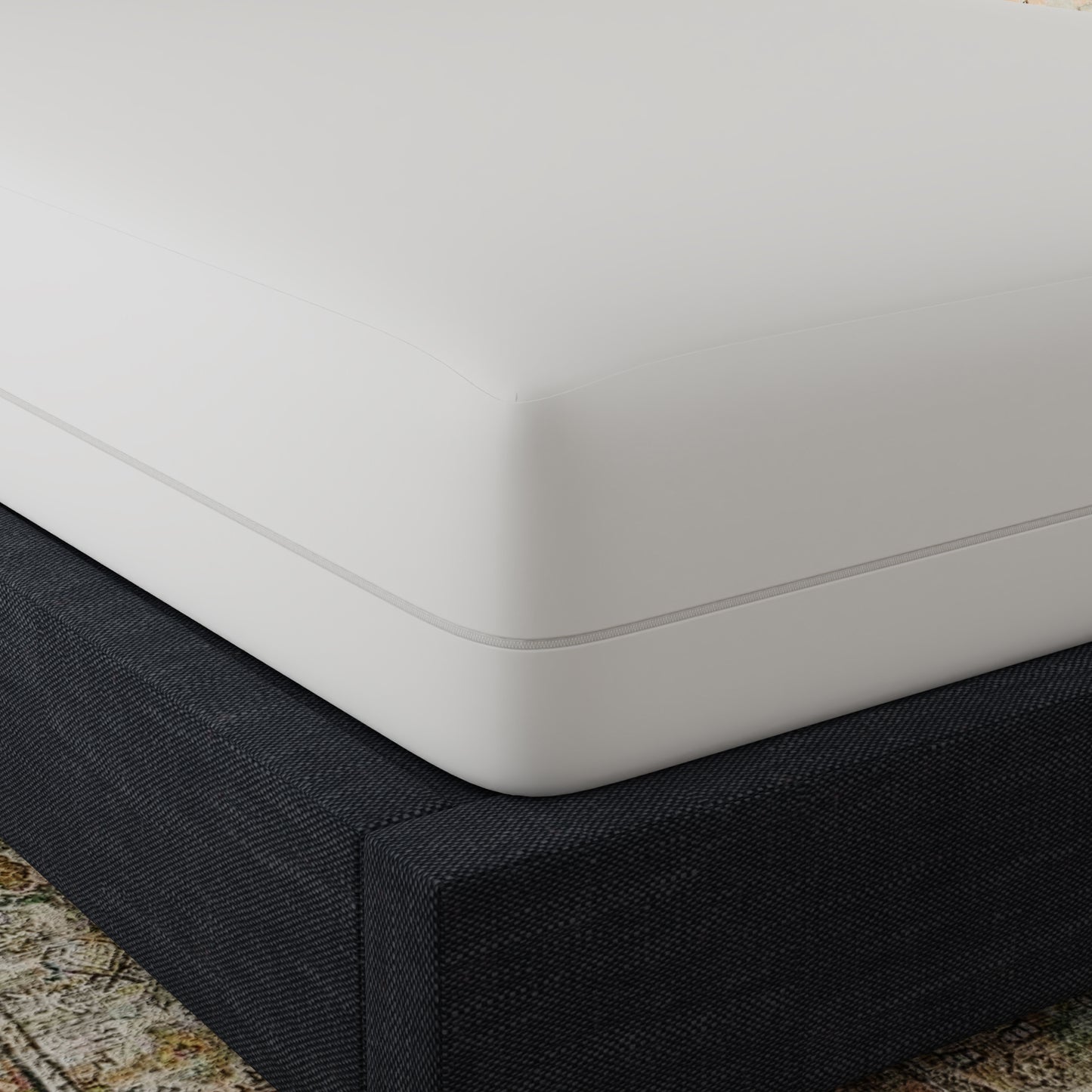 Closeup of a white mattress with a grey zipper detail resting on a dark grey textured bed base