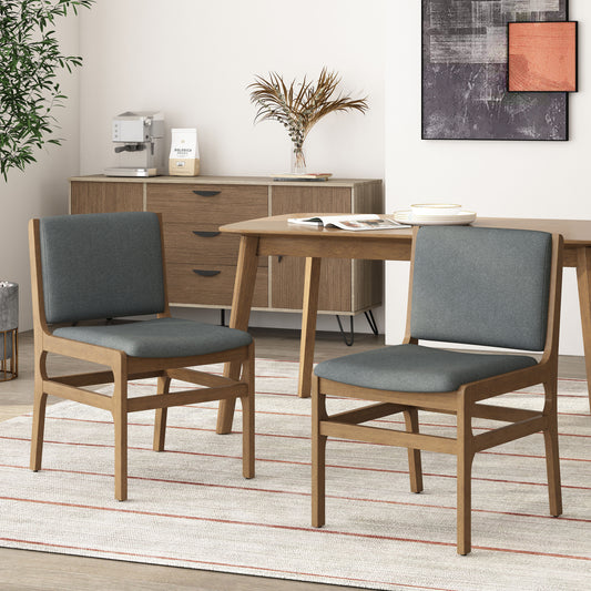 Two modern upholstered dining chairs with dark grey fabric seats and backs and natural wood frames