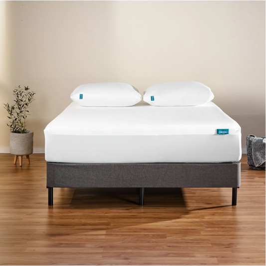 White Ooki bedding set on a dark grey upholstered bed frame featuring two plush pillows and a white fitted sheet