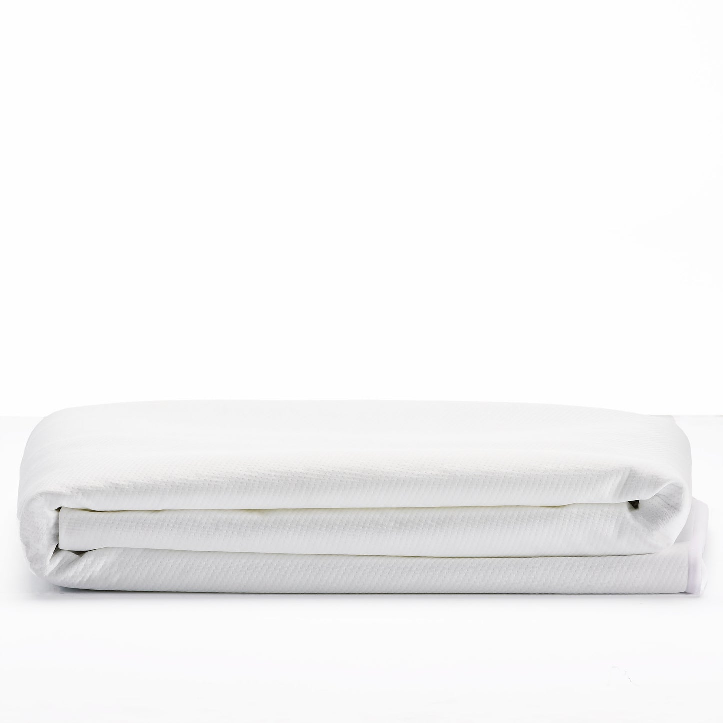 Folded white duvet cover with subtle textured fabric pattern