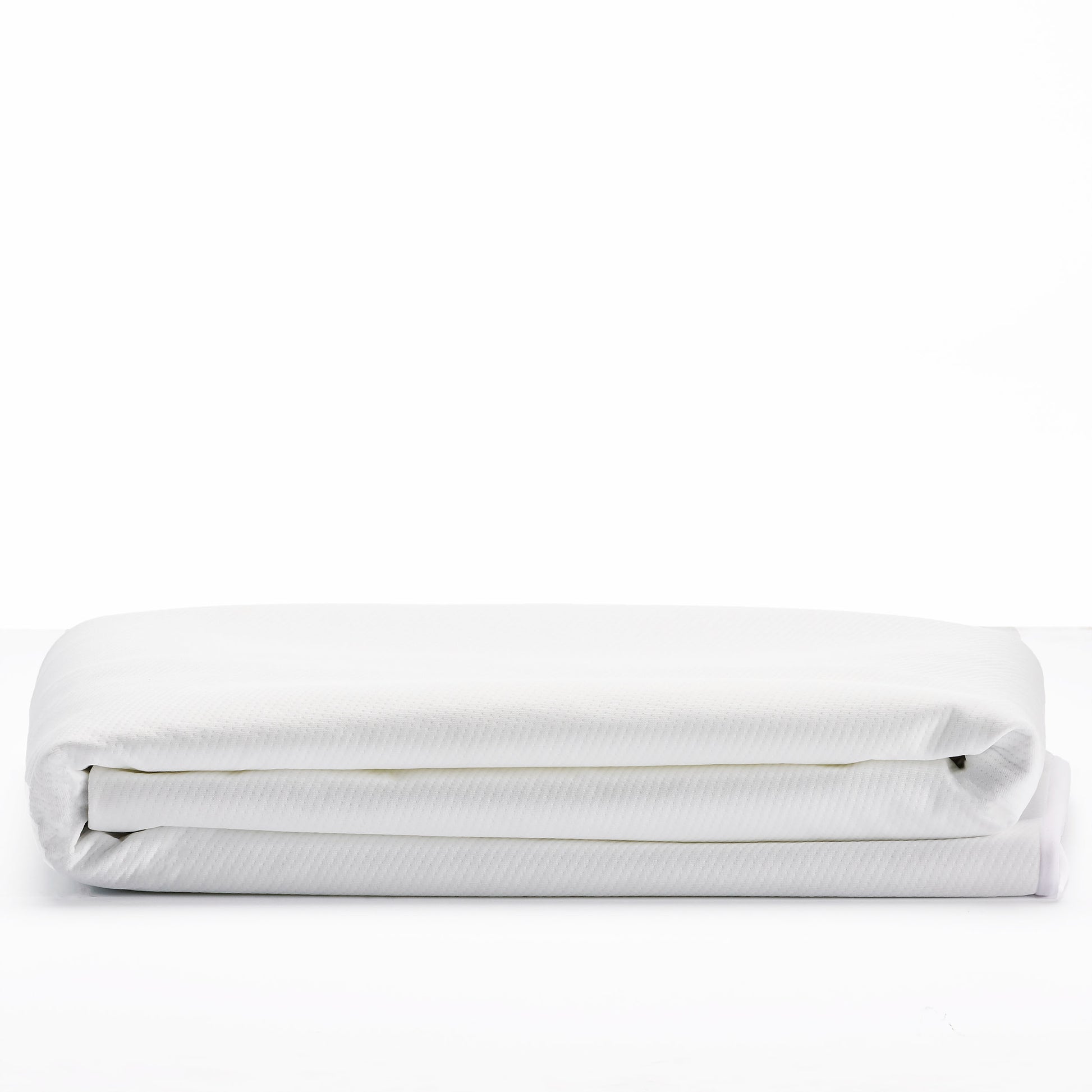 Folded white cotton bed sheet with subtle texture perfect for a cozy bedroom