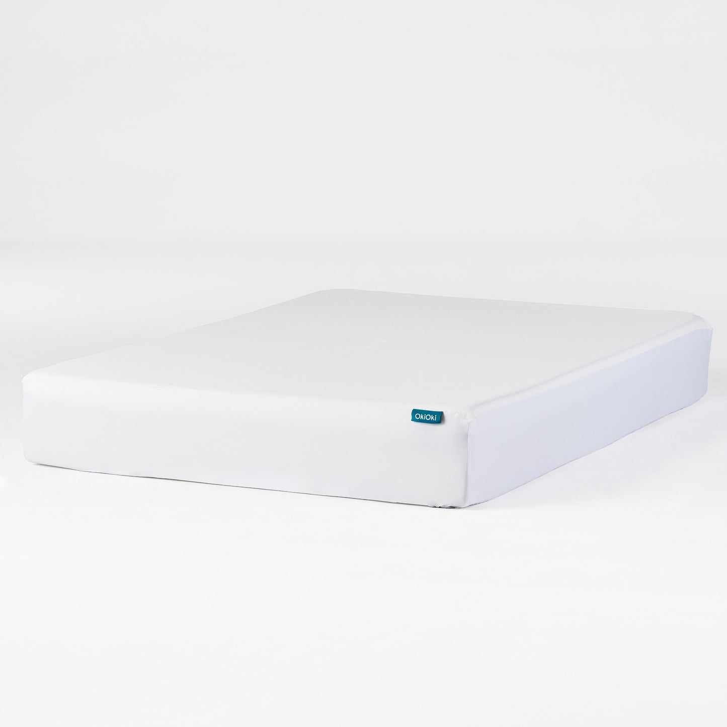 White OkiOki mattress with a teal logo tag ideal for comfortable sleep