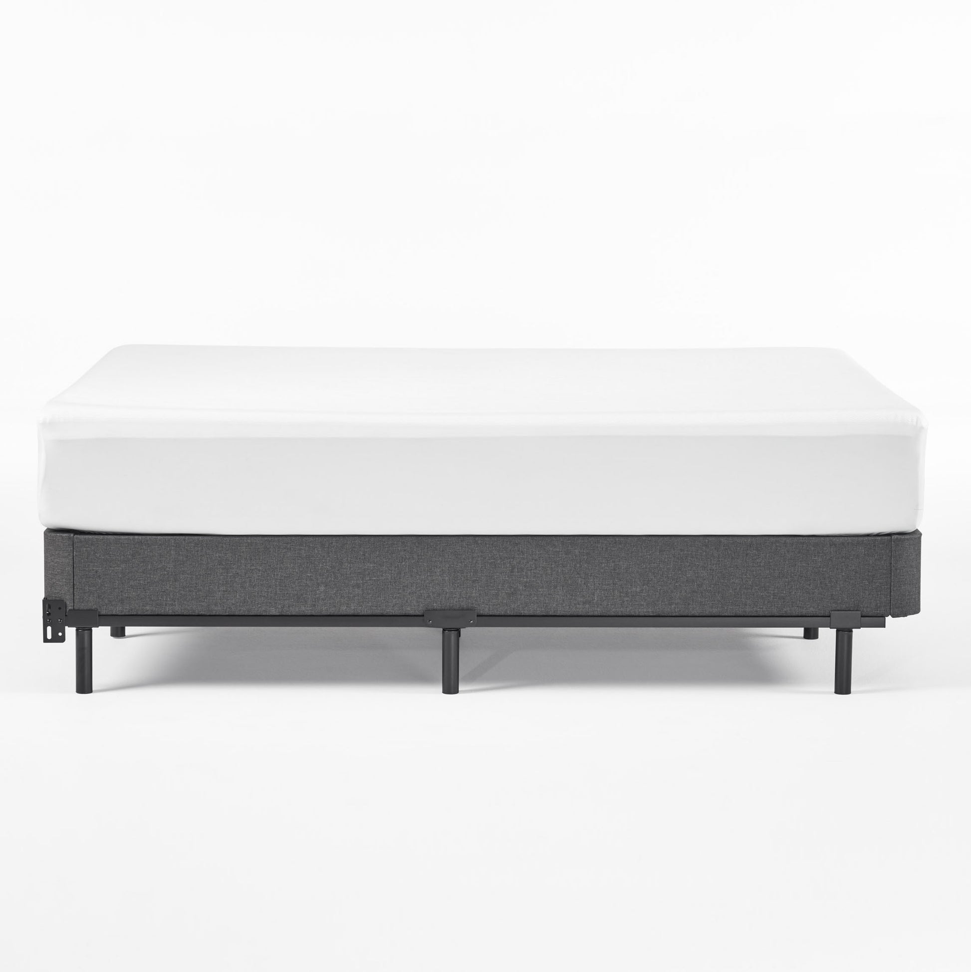 Gray upholstered mattress foundation with white fitted sheet inch height