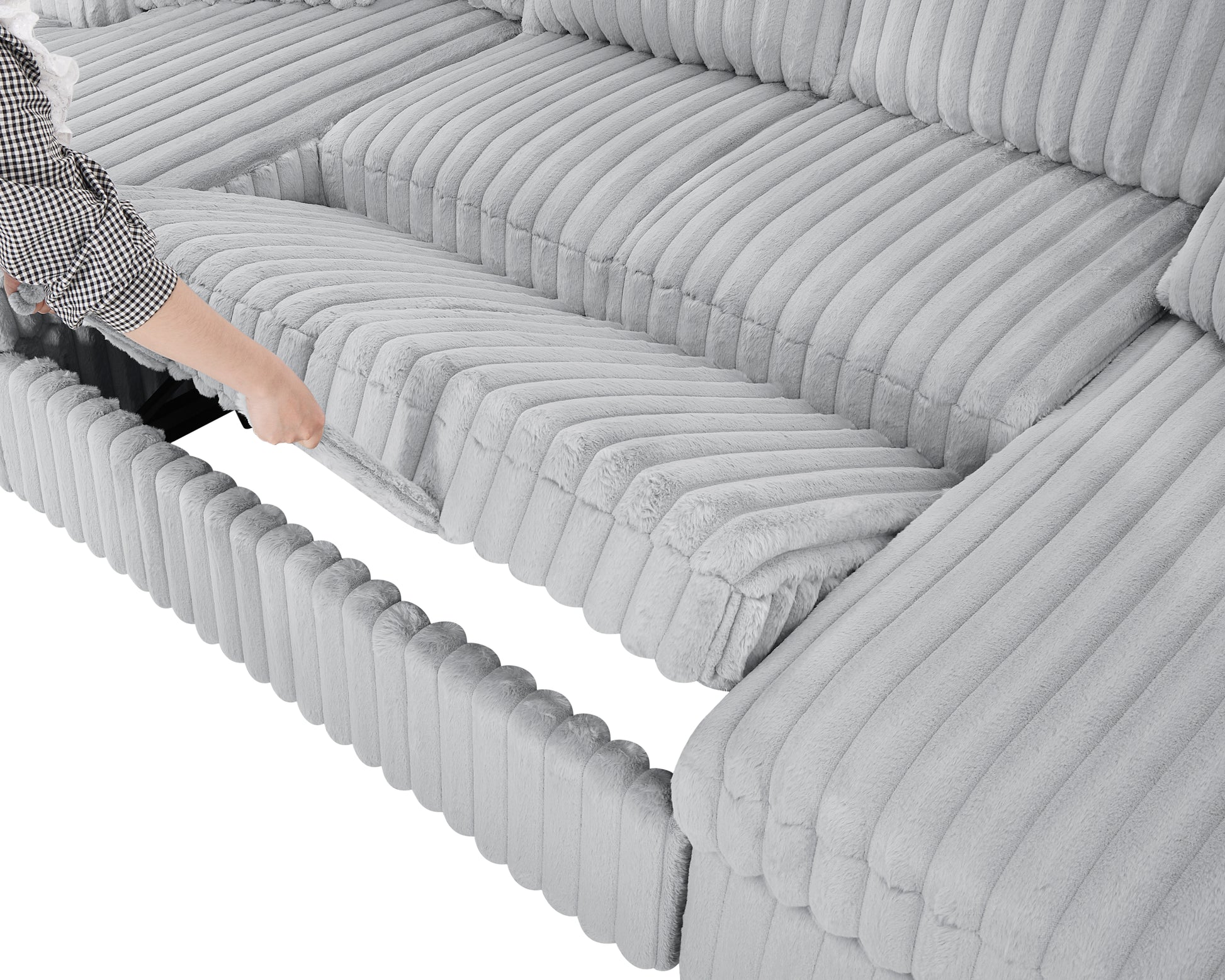 Hand pulling open a storage compartment on a plush grey sectional sofa