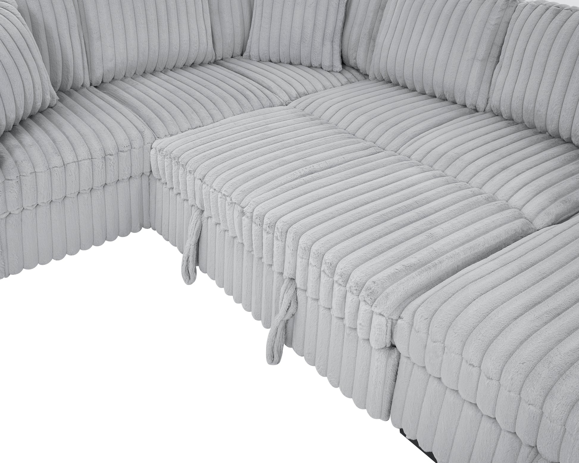 Plush grey corduroy sectional sofa with matching throw pillows perfect for a cozy living room