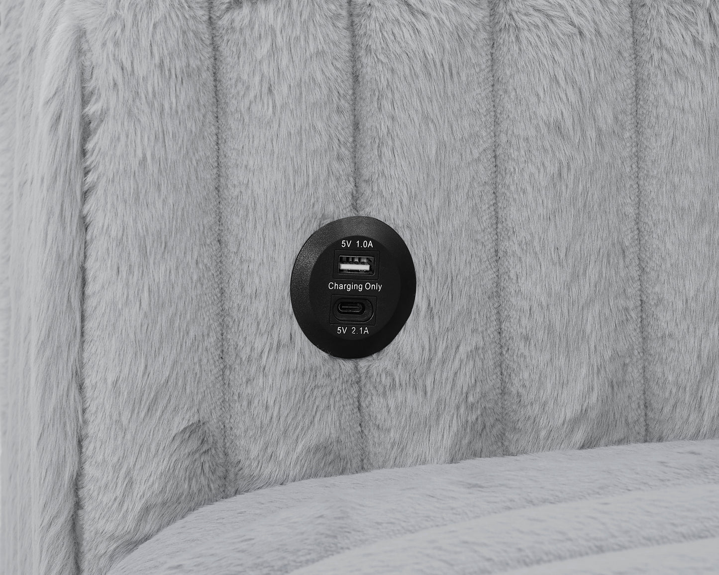 Closeup of a gray faux fur fabric with a builtin USB charging port for convenient device power