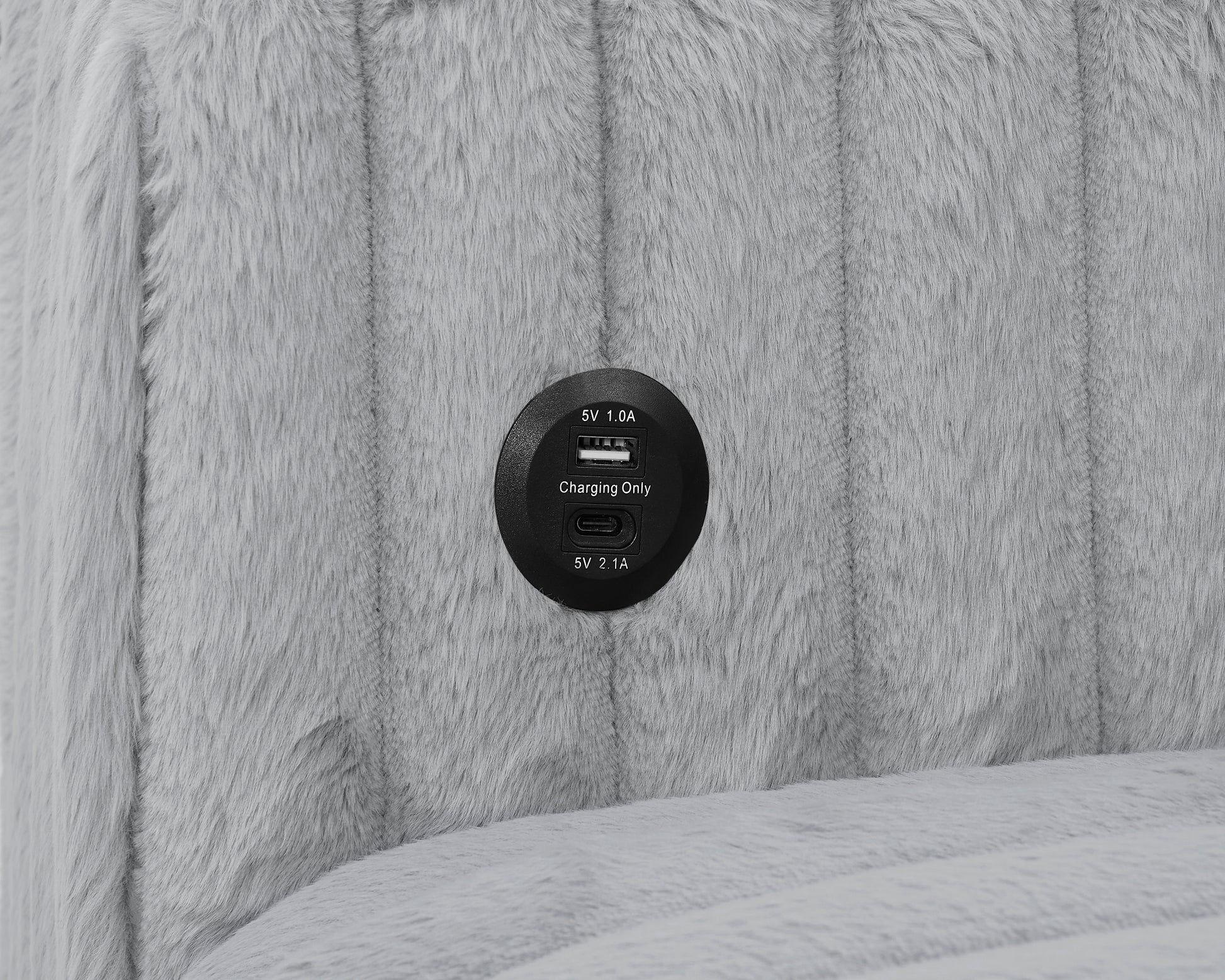 Closeup of a gray faux fur fabric with a builtin USB charging port for convenient device power