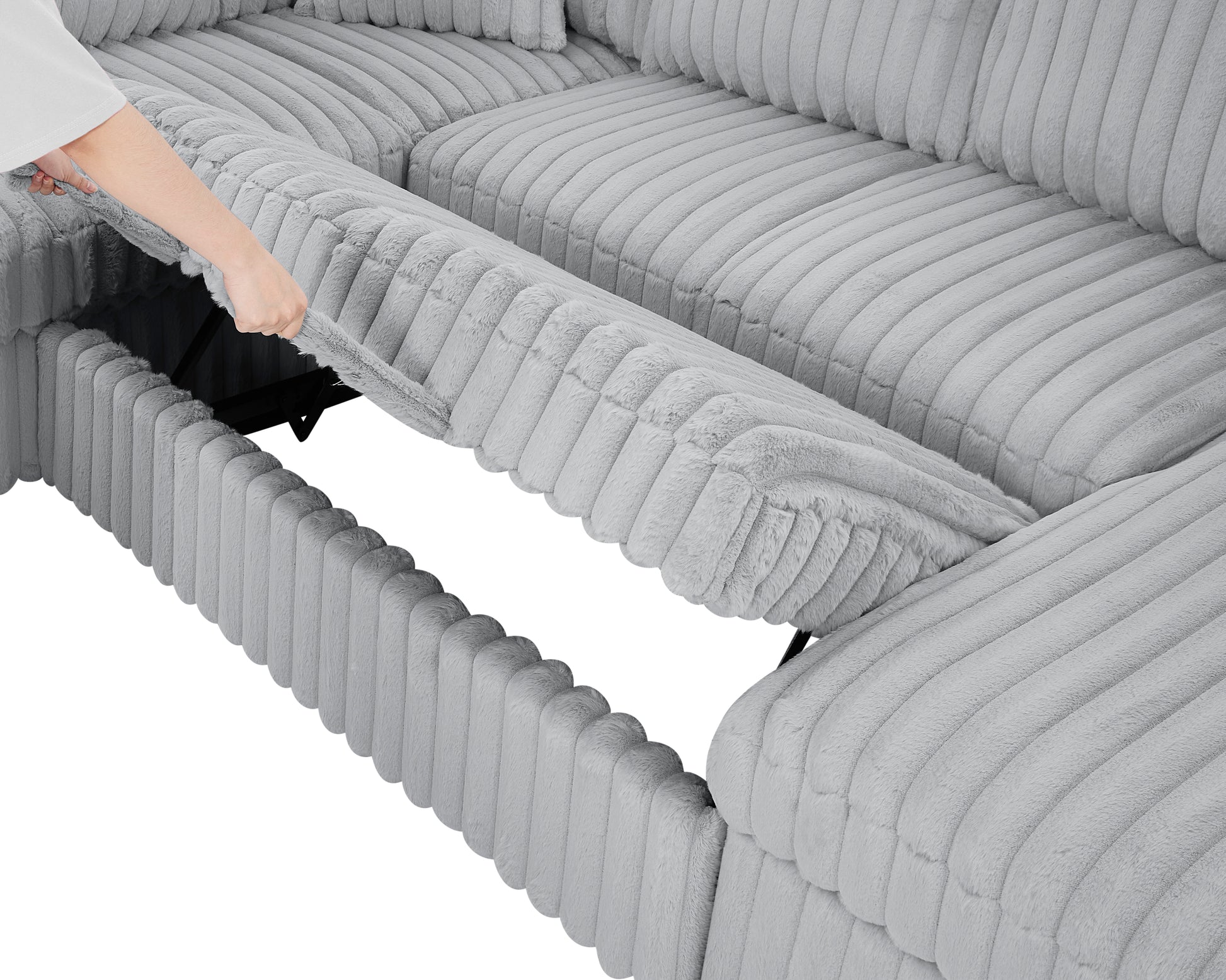 Gray plush sectional sofa with storage compartment being pulled open by a hand