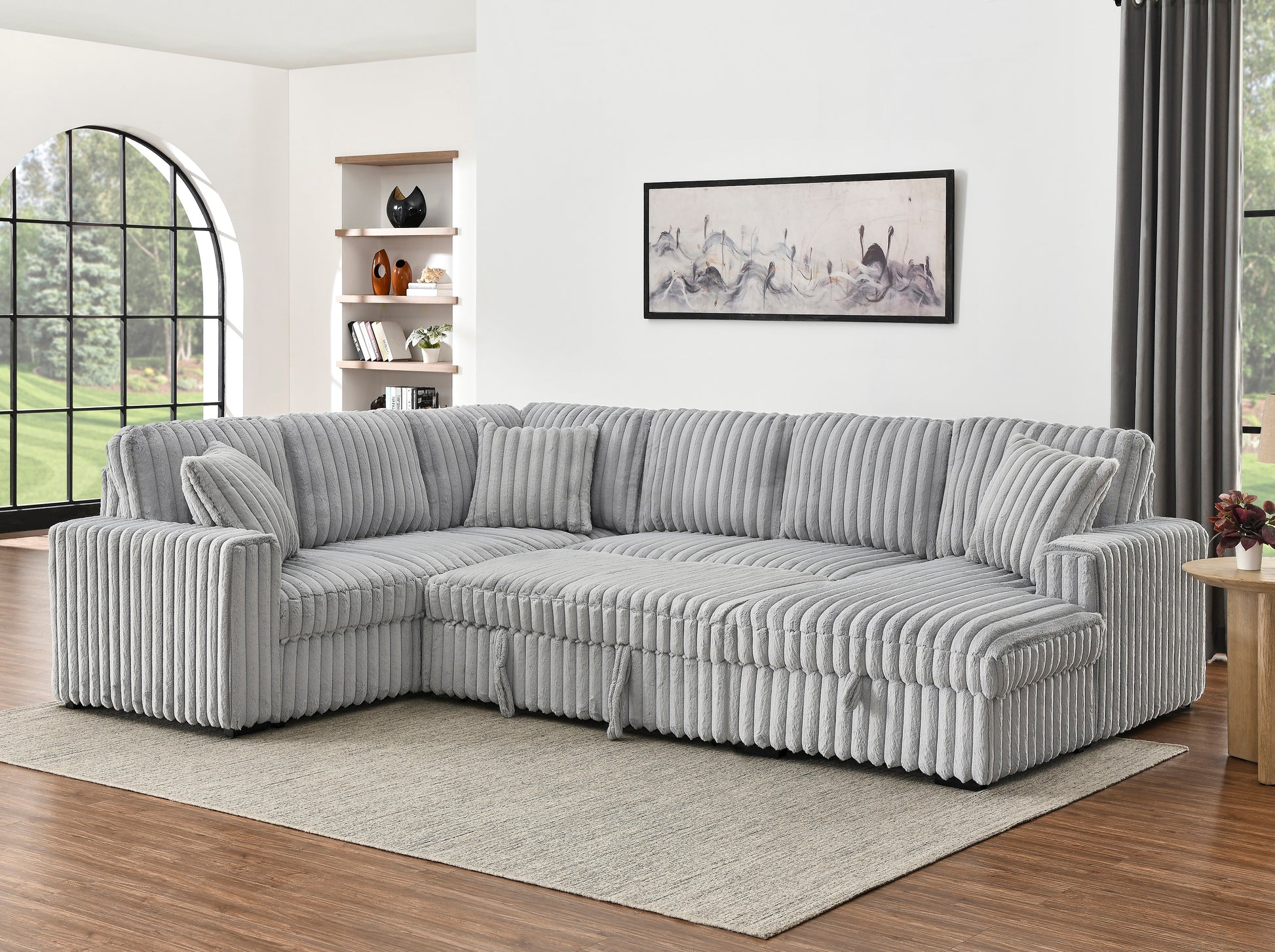 Plush grey corduroy sectional sofa with multiple accent pillows perfect for living room comfort