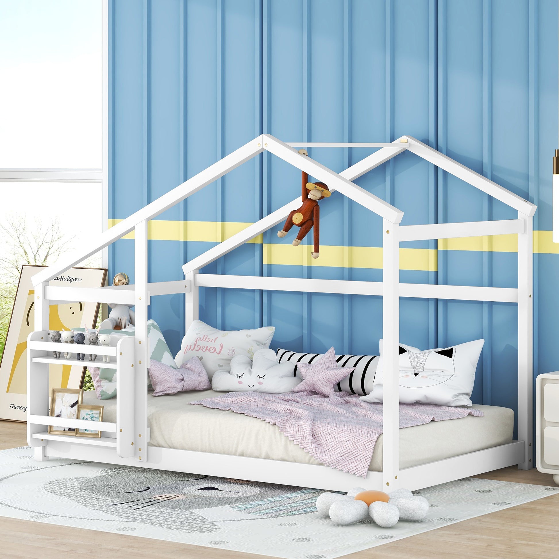 White wooden house bed frame with playful pillows and stuffed toys