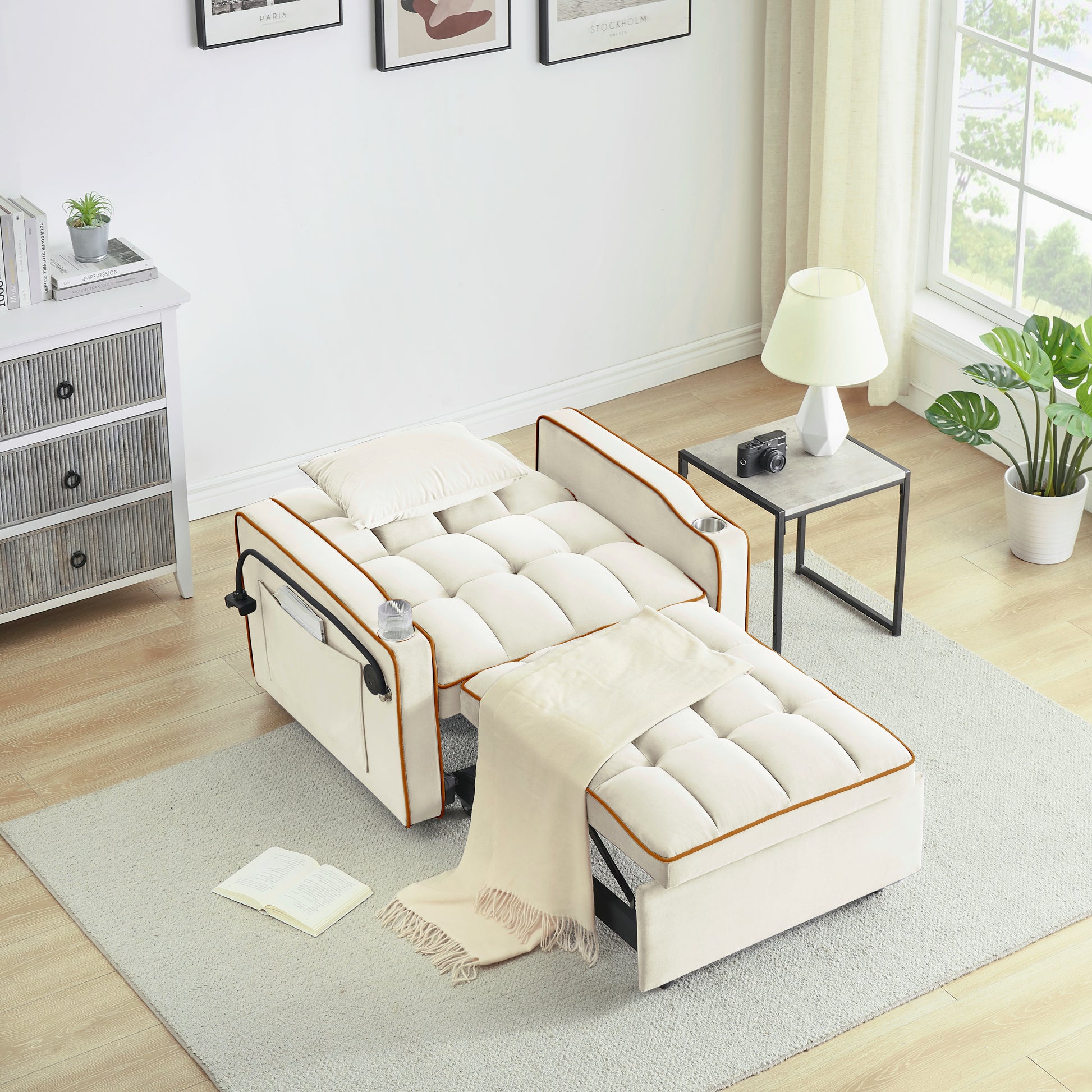 Cream upholstered convertible sleeper sofa with tufted cushions and orange trim