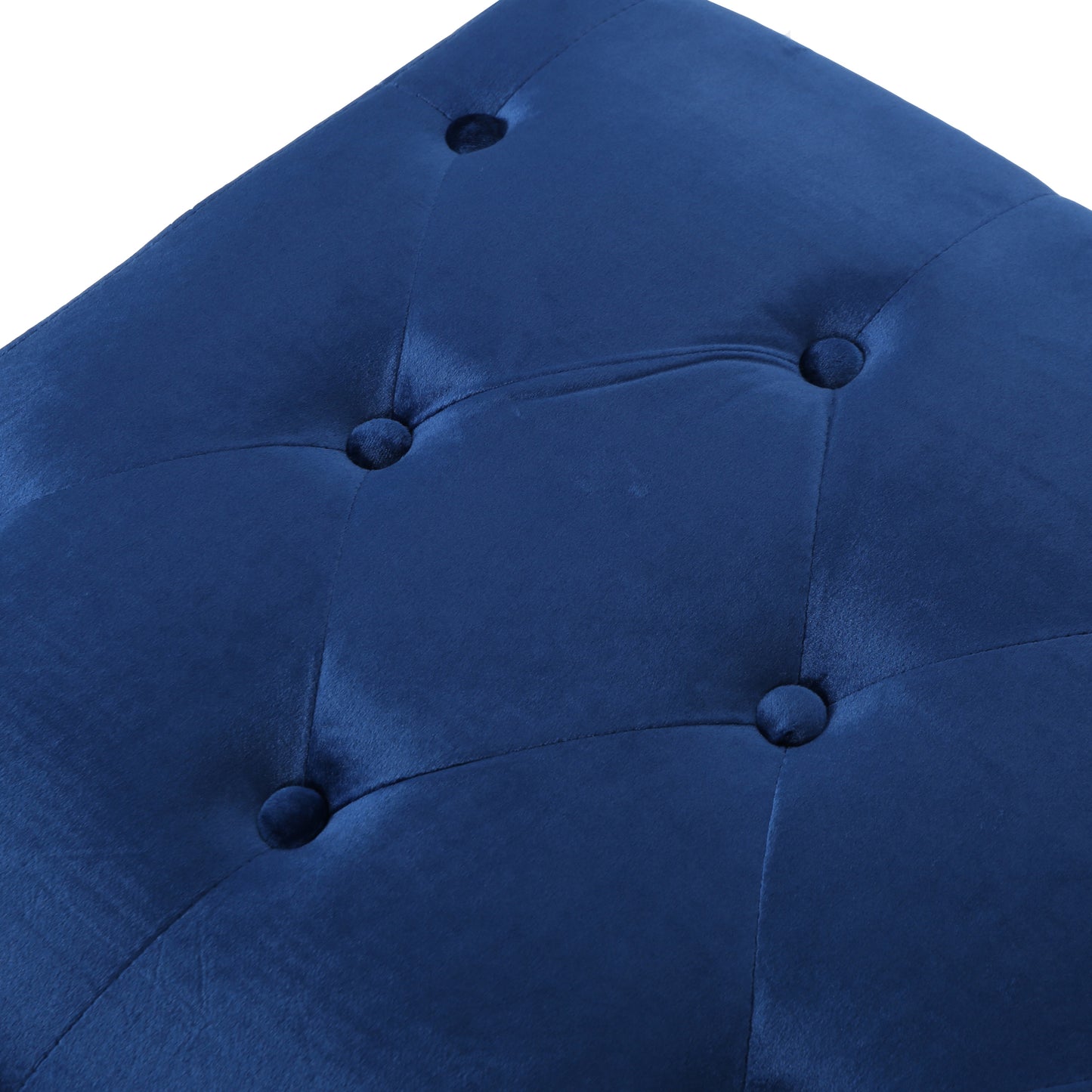 Closeup of tufted navy blue velvet ottoman with button detail
