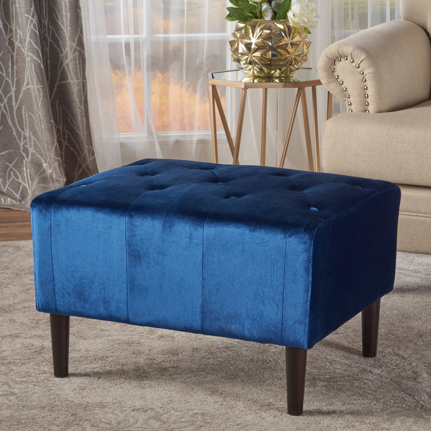 Tufted navy velvet ottoman with dark wood legs perfect accent for living rooms