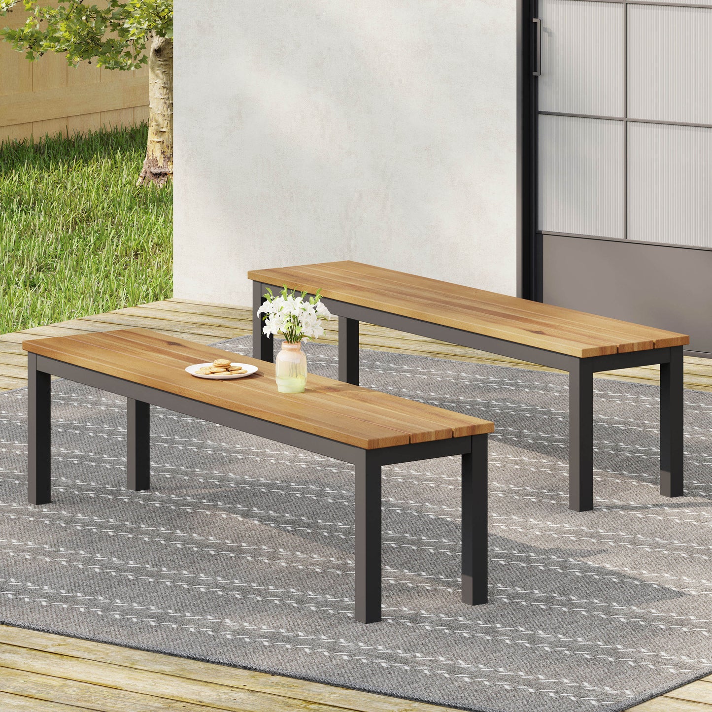 Two slatted wooden benches with dark metal frames on a patio rug