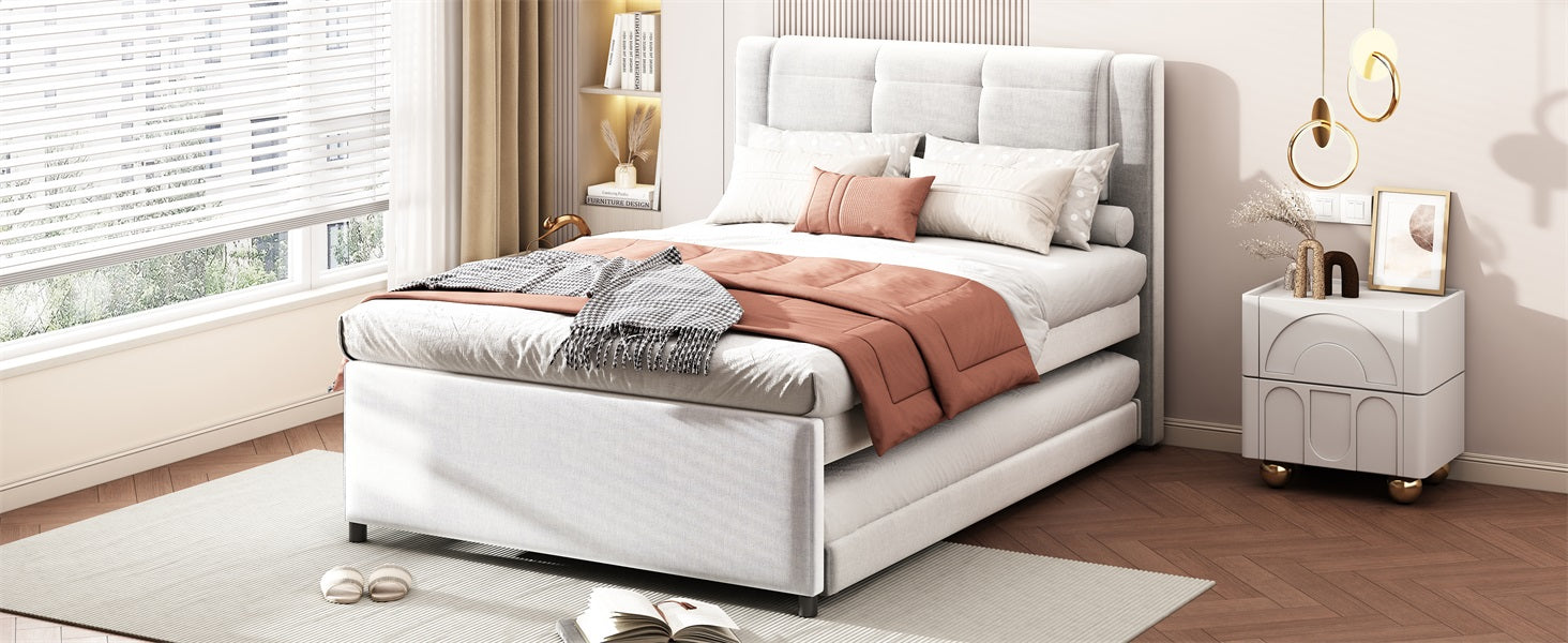 White upholstered queen bed frame with pullout trundle perfect for guest rooms